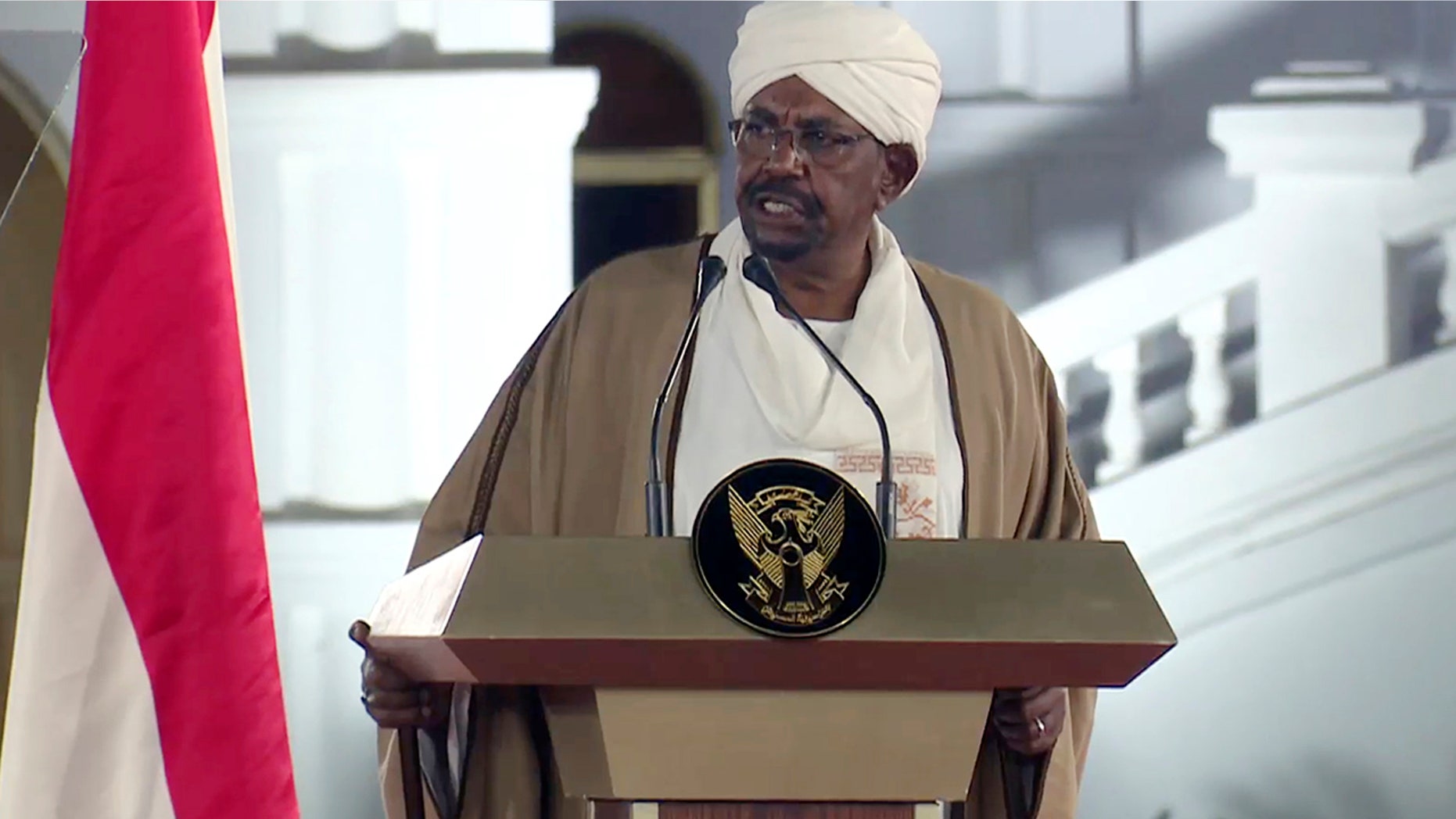 FILE - In this file image taken from video, Sudan's President Omar al-Bashir speaks at the Presidential Palace, Friday, Feb. 22, 2019, in Khartoum, Sudan. Tens of thousands of Sudanese were making their way to the center of the country’s capital on Thursday, April 11, 2019, cheering and clapping in celebration as two senior officials said the military had forced longtime autocratic President Omar al-Bashir to step down after 30 years in power.(AP Photo/Mohamed Abuamrain, File)