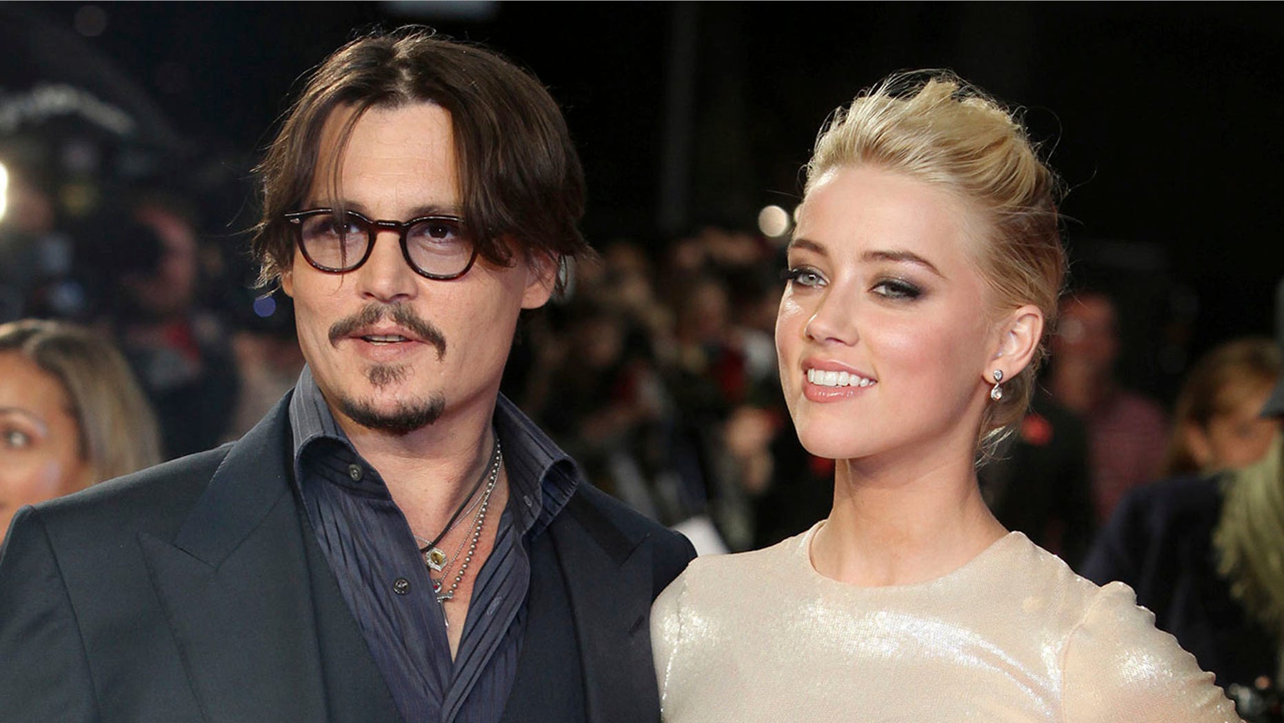 Johnny Depp, left, and Amber Heard arrive for the European premiere of their film, "The Rum Diary," in London.