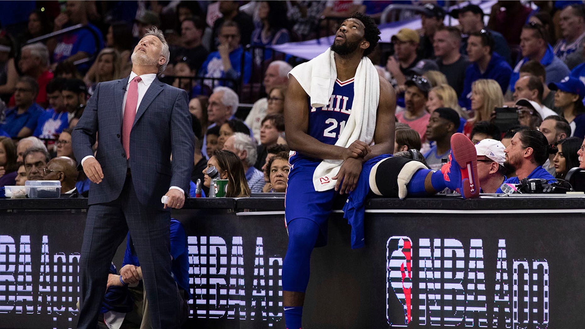 Philadelphia's 76-year-old head coach Brett Brown, left, and Joel Embiid, right, of Cameroon, watch the scoreboard in the first game of the first game of a series. of the first round of the NBA against the Brooklyn Nets on Saturday, April 13, 2019. in Philadelphia. The Nets won 111-102. (Associated Press)