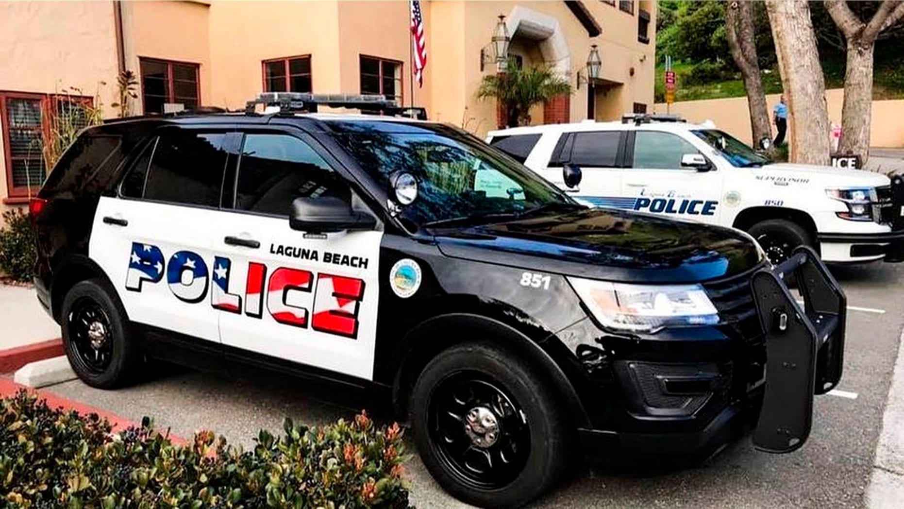 This undated photo provided by the Laguna Beach Police Department shows its newly decorated SUV police patrol vehicles in Laguna Beach, California. Seven of the department's 11 cars have already been painted, the department said in a message to the Los Angeles Times. 