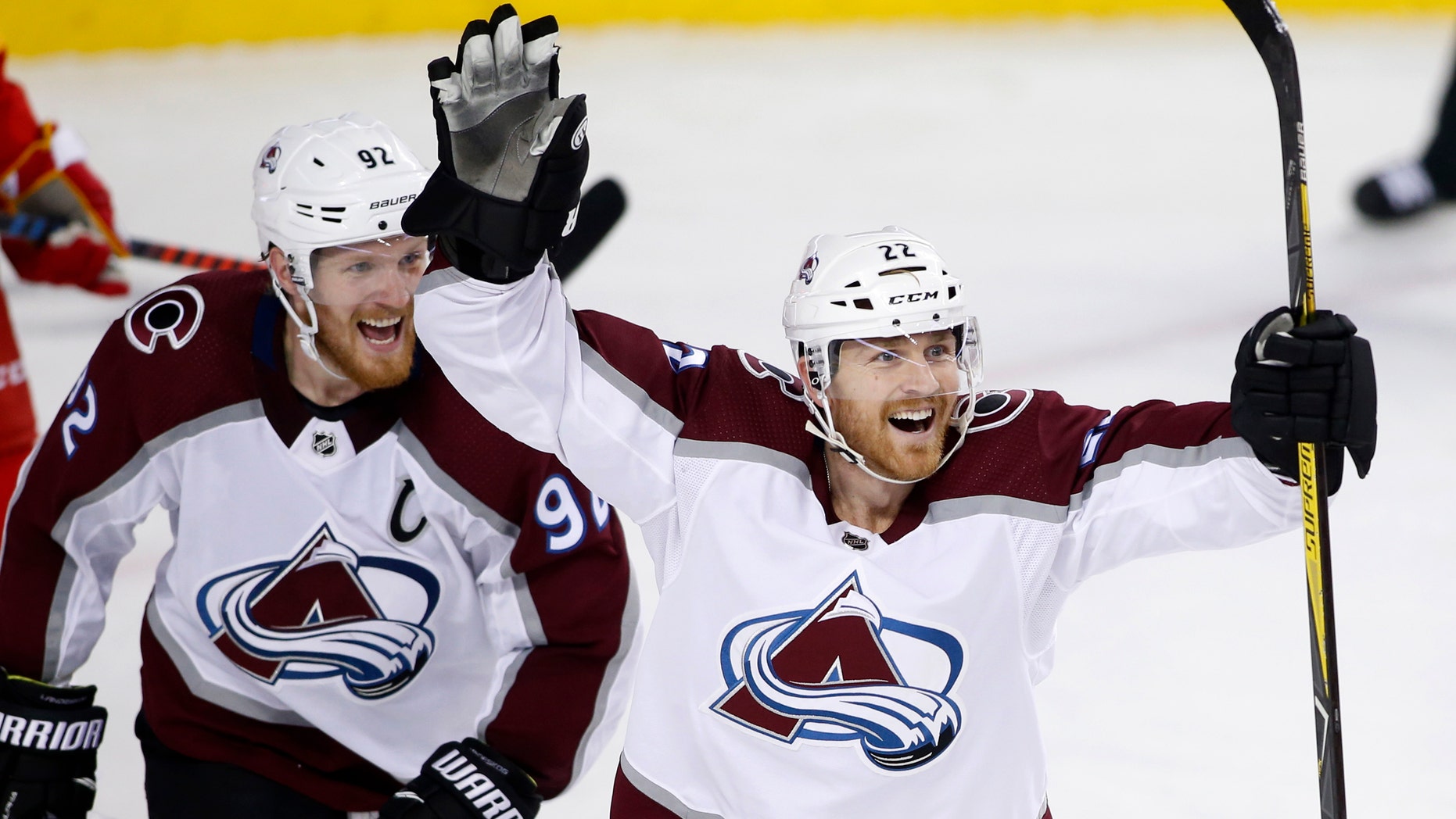 Colorado Avalanche center Colin Wilson (22) celebrates his goal against the Calgary Flames with teammate Gabriel Landeskog (92) during the second period of Game 5 of an NHL hockey first-round playoff series Friday, April 19, 2019, in Calgary, Alberta.