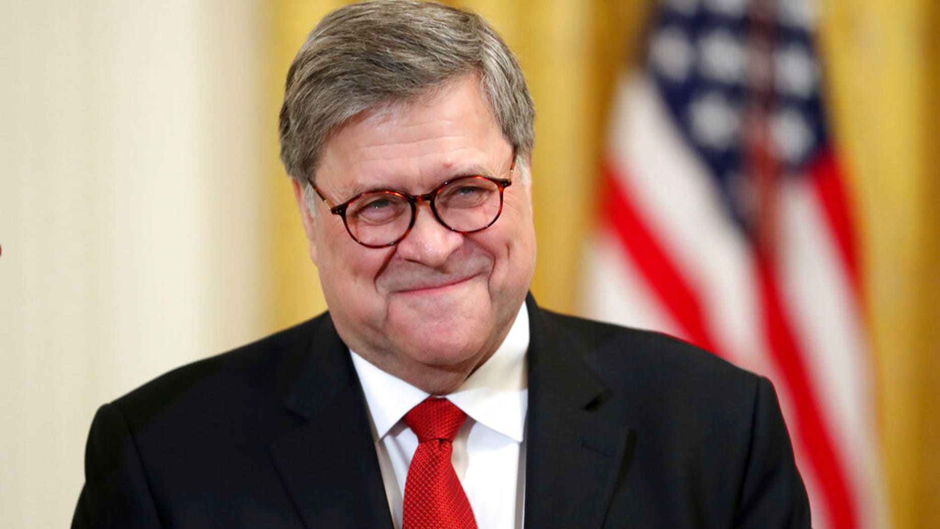 Attorney General William Barr smiles as he waits for President Donald Trump to speak at the 2019 Prison Reform Summit and First Step Act Celebration in the East Room of the White House in Washington, Monday, April 1, 2019. (AP Photo/Andrew Harnik)