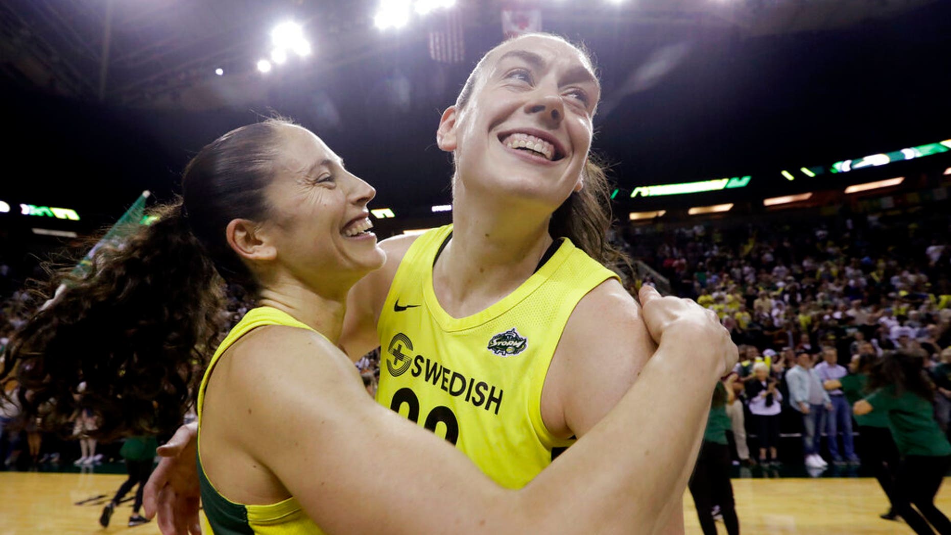 FILE - In this Sept. 4, 2018, file photo, Seattle Storm's Breanna Stewart, right, is embraced by Sue Bird after the Storm defeated the Phoenix Mercury 94-84 during Game 5 of a WNBA basketball playoff semifinal, in Seattle. The WNBA's 23rd season begins May 24, with the Seattle Storm the defending champion. (AP Photo/Elaine Thompson, File)