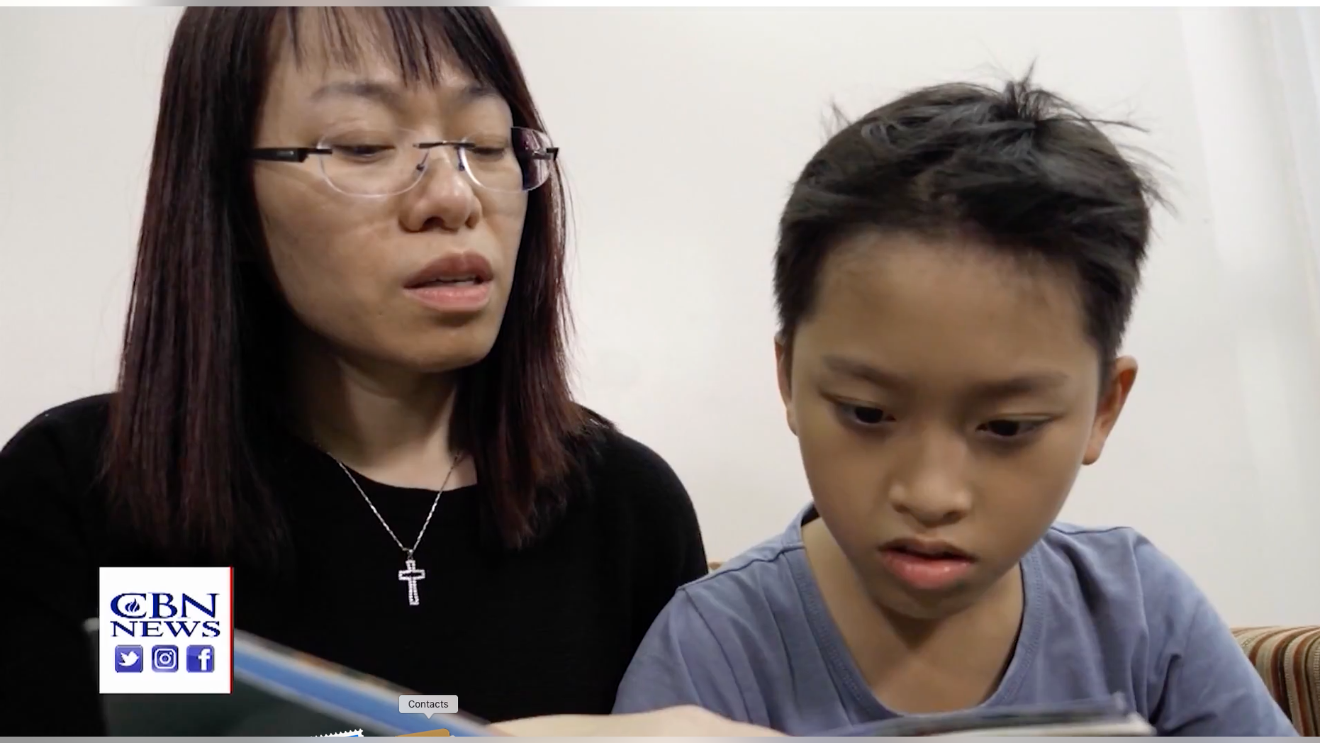 Ngocanh Le and her son, Minh Viet, look at the Superbook program that brings the Bible to life in an animated way. it was translated into their local Vietnamese language.
