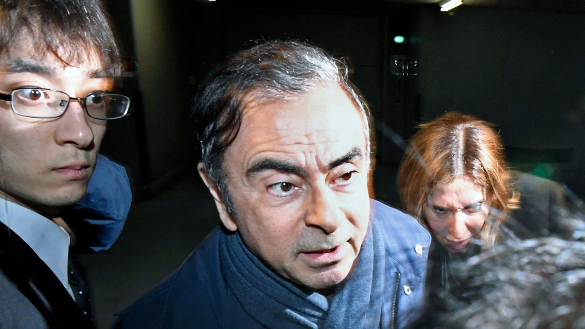 Former Nissan Chairman Carlos Ghosn, center, leaves his lawyer's office in Tokyo Wednesday. (Sadayuki Goto/Kyodo News via AP, File)