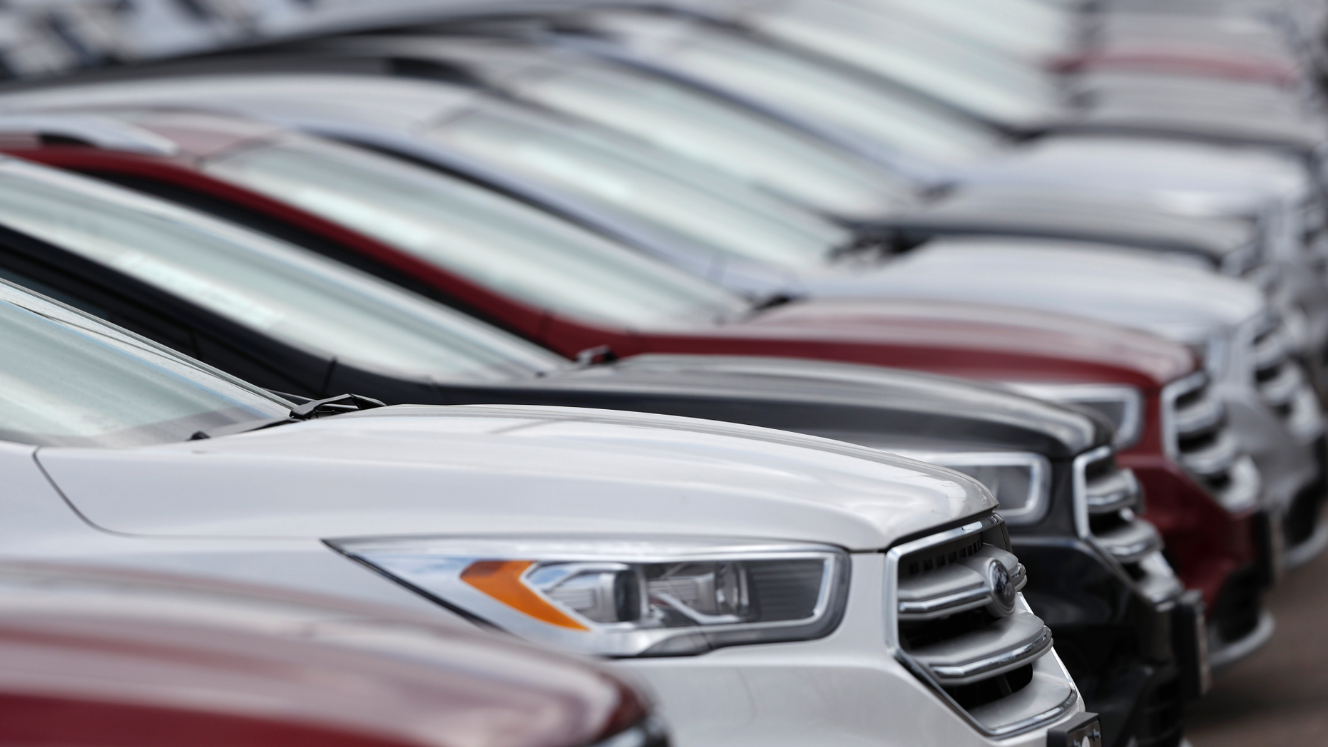 FILE- In this Sunday, Feb. 17, 2019, file photo, unsold 2019 Escape sports-utility vehicles sit in a long row at a Ford dealership in Broomfield, Colo. On Tuesday, April 2, the Commerce Department releases its February report on durable goods. (AP Photo/David Zalubowski, File)