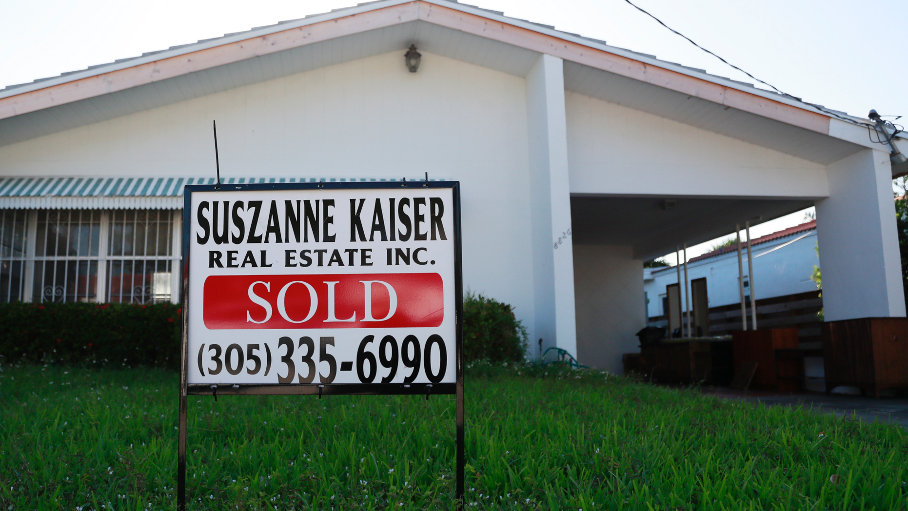 In this Friday, April 12, 2019 photo, a sold sign is shown in front of a home in Surfside, Fla. The National Association of Realtors is expected to report on Monday, April 22, that sales slid to a seasonally adjusted annual rate of 5.35 million last month.(AP Photo/Wilfredo Lee)