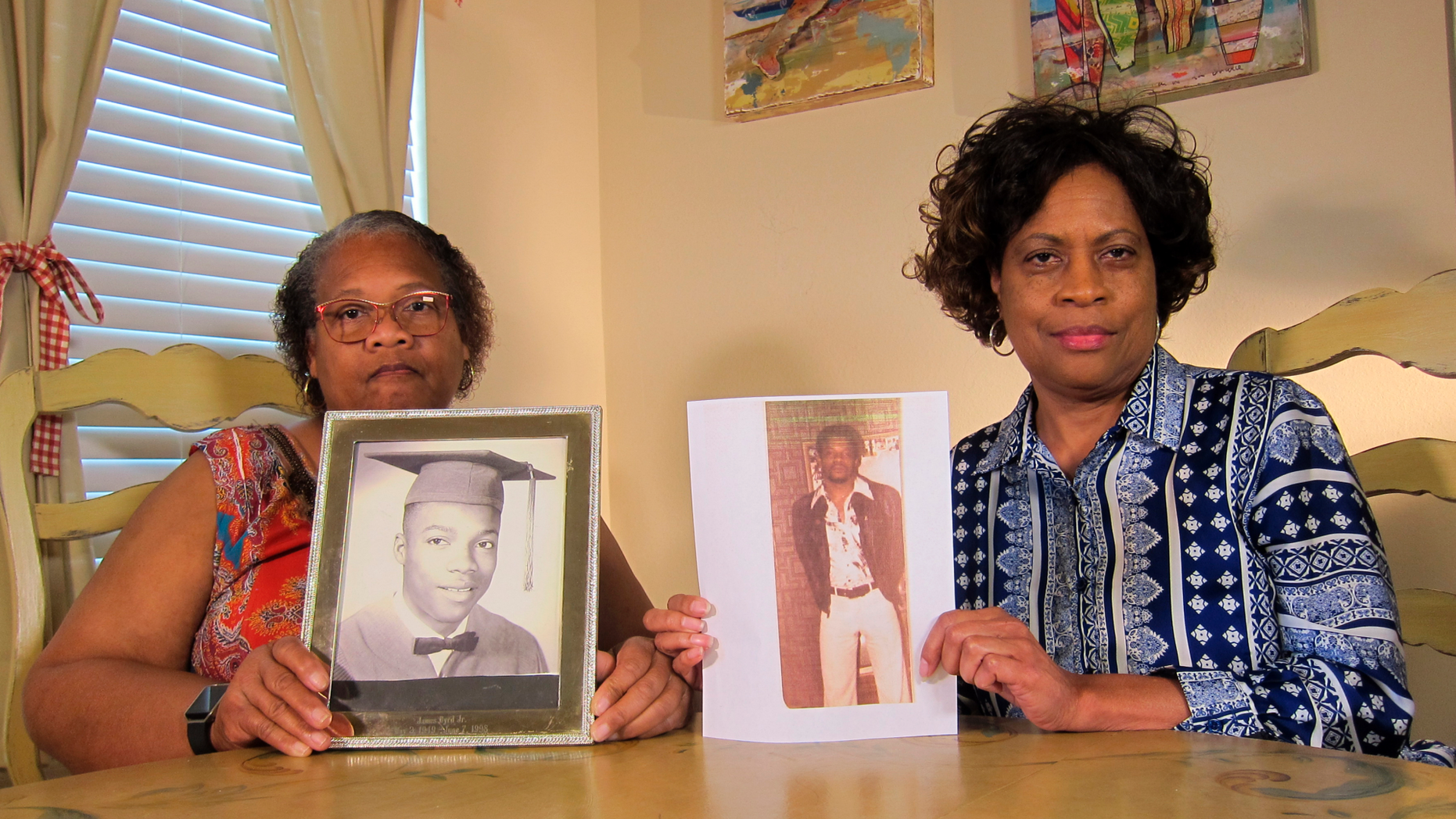 On Wednesday, April 10, 2019, the photo Mylinda Byrd Washington, 66, on the right, and Louvon Byrd Harris, 61, present photographs of their brother James Byrd Jr. in Houston. James Byrd Jr. has fallen victim to what is considered one of the most abominable hate crime murders in recent Texas history. (AP Photo / Juan Lozano)