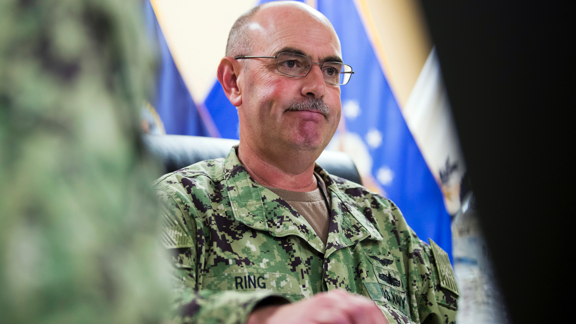 FILE - In this Wednesday, April 17, 2019, file photo reviewed by U.S. military officials, U.S. Navy Rear Adm. John Ring, Joint Task Force Guantanamo Commander, pauses while speaking during a roundtable discussion with the media, at Guantanamo Bay Naval Base, Cuba. Military officials say that Ring has been fired for a “loss of confidence in his ability to command.” A statement from U.S. Southern Command says Ring was relieved of duty Saturday, April 27. (AP Photo/Alex Brandon, File)