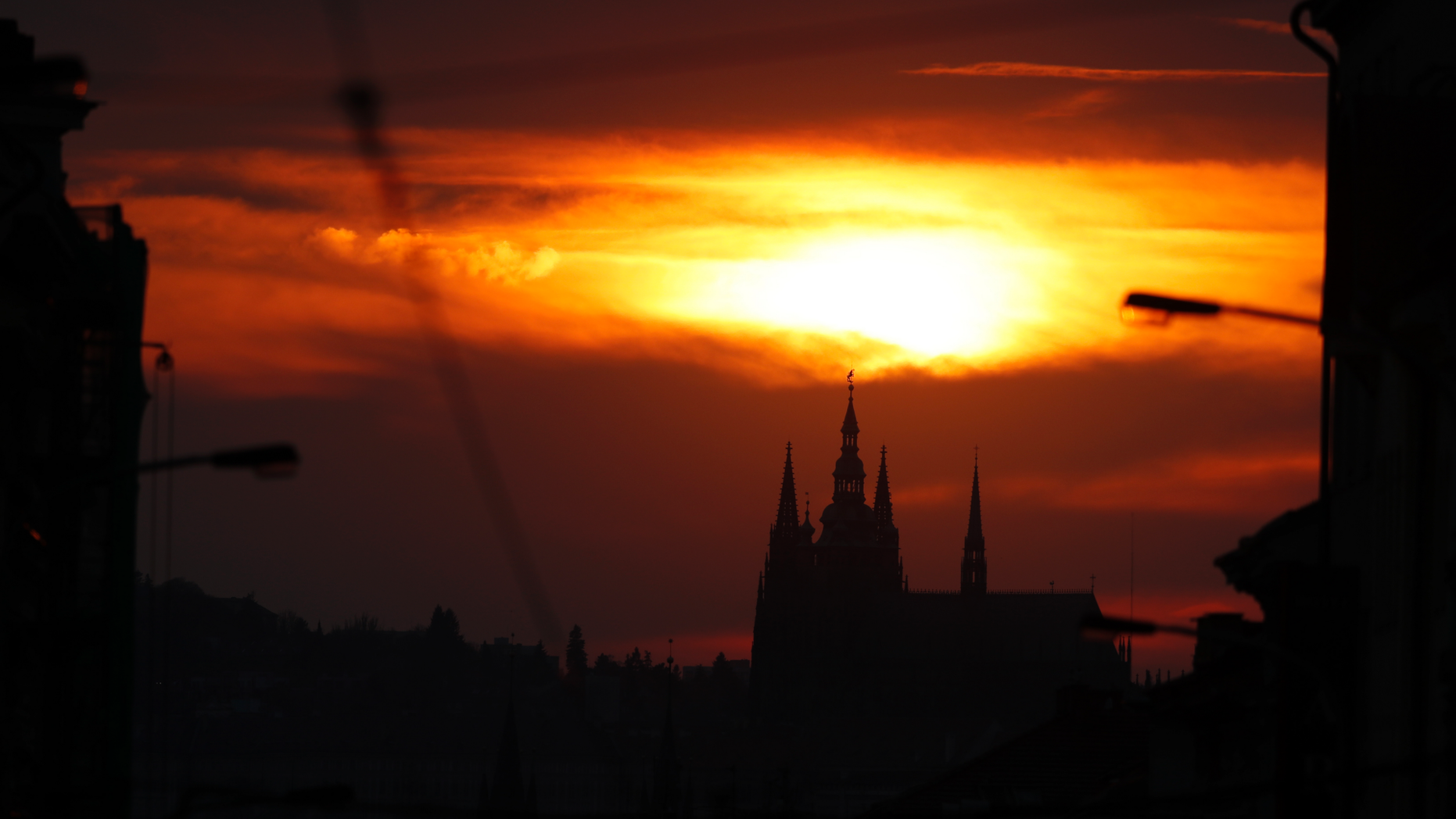 FILE - In this Wednesday, April 10, 2019 file photo, the sun sets behind the St. Vitus cathedral in Prague, Czech Republic. On Tuesday, April 23, 2019, Czech Parliament's lower house has overridden a veto of the upper house to approve a proposal drafted by Communist lawmakers to tax the compensation that the country's churches receive for property seized by the former Communist regime. (AP Photo/Petr David Josek/File)