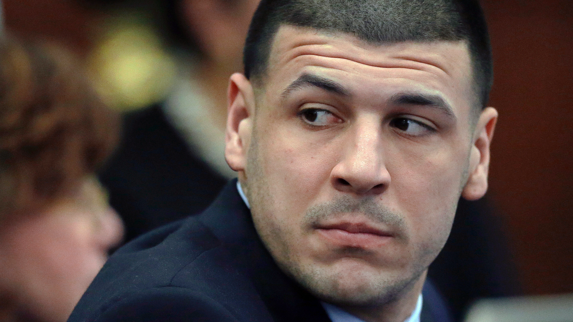 FILE - In this March 29, 2017, file photo, Aaron Hernandez listens during his double murder trial in Suffolk Superior Court in Boston. He already was serving a life sentence in the 2013 killing of semi-professional football player Odin Lloyd. Attorneys for the late former New England Patriots NFL football filed documents on Friday, April 12, 2019, saying that the state Supreme Judicial Court got it wrong when it ordered in March that Hernandez's conviction in the Lloyd case be restored. The court's decision did away with the legal principle that erased Hernandez's conviction after the 27-year-old killed himself in his prison cell in 2017. (AP Photo/Elise Amendola, Pool, File)