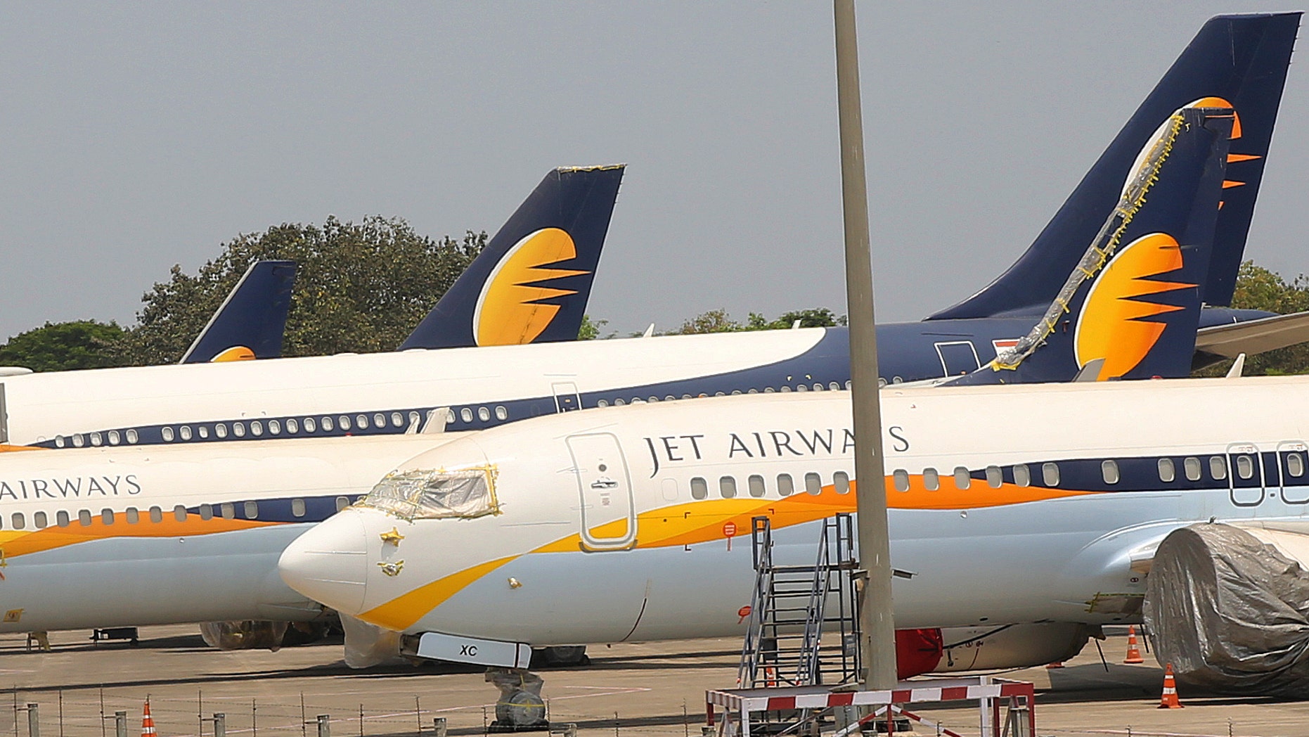 Jet Airways aircrafts are seen parked at Chhatrapati Shivaji Maharaj International Airport in Mumbai, Monday, April 15, 2019. India's ailing Jet Airways has drastically reduced operations amid talks with investors to purchase a controlling stake in the airline and help it reduce its mounting debt. (AP Photo/Rafiq Maqbool)