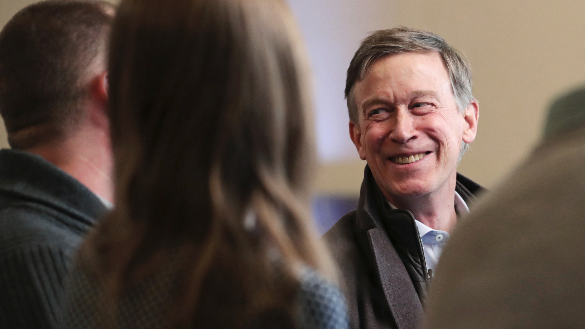 Former Democratic Colorado Governor John Hickenlooper smiles during a meeting with AmeriCorps members at a roundtable campaign stop in Manchester, N.H., Friday, March 22, 2019. Hickenlooper joined the 2020 Presidential race earlier in the month. (AP Photo/Charles Krupa)