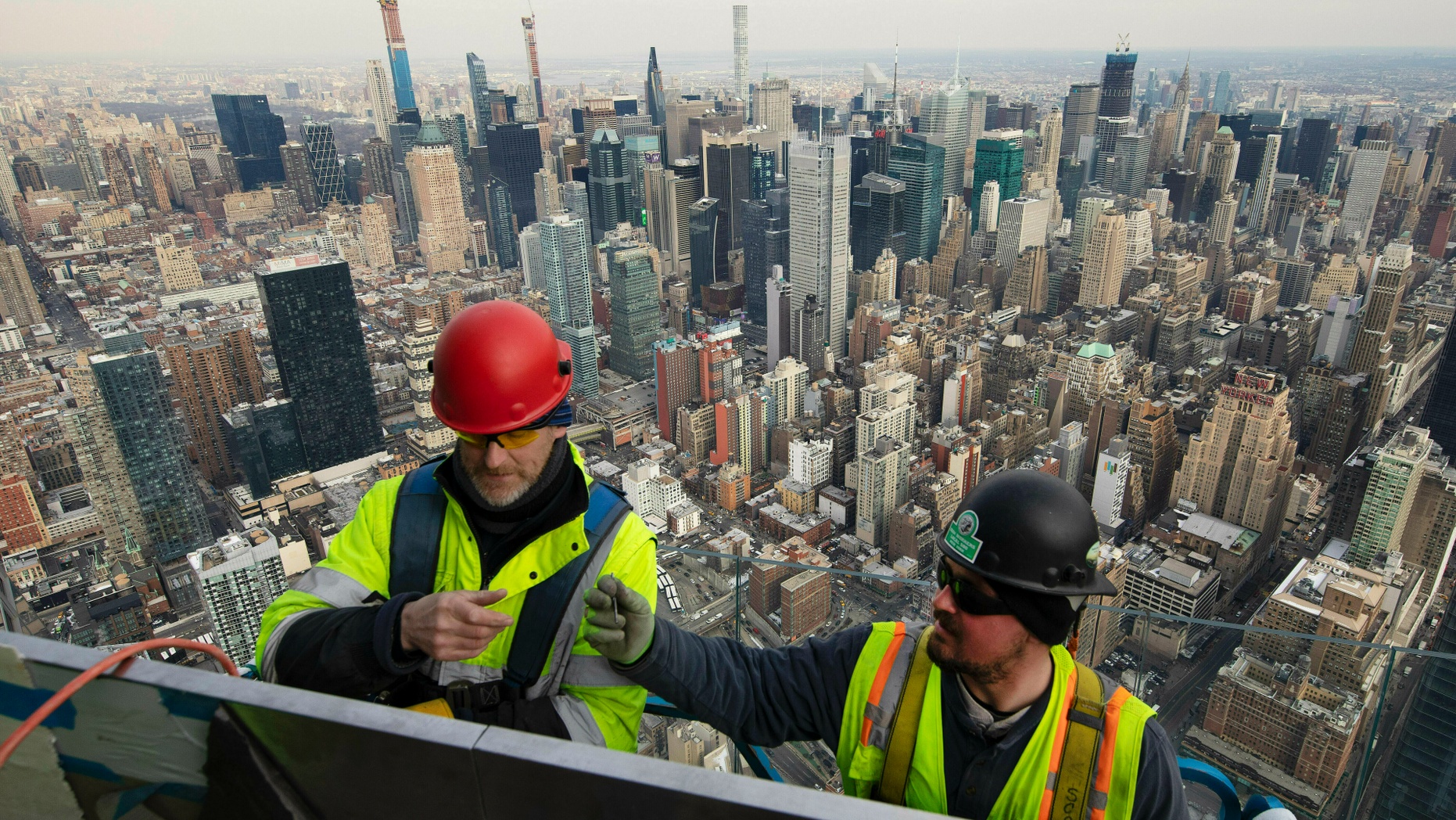 FILE- In this March 8, 2019, file photo, work continues on an outdoor observation deck on the 30 Hudson Yards office building in New York. On Monday, April 1, the Commerce Department reports on U.S. construction spending in February. (AP Photo/Mark Lennihan, File)