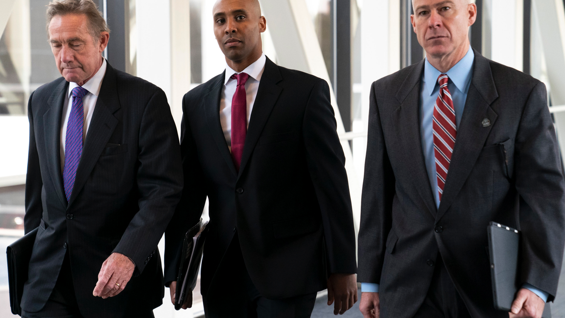 FILE - In this April 1, 2019, file photo, former Minneapolis police officer Mohamed Noor, center, arrives for the first day of jury selection with his attorneys Peter Wold, left, and Thomas Plunkett, at the Hennepin County Government Center in Minneapolis, Minn. Noor is charged in the July 2017 death of Justine Ruszczyk Damond, who was killed after she called 911 to report a possible sexual assault behind her home.(Renee Jones Schneider/Star Tribune via AP, File)