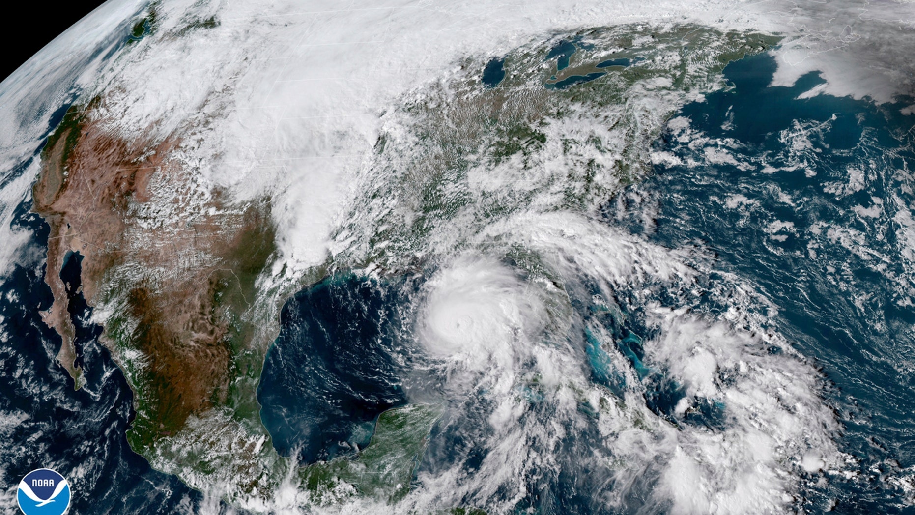 FILE - This Oct. 9, 2018, file photo shows a satellite image made available by NOAA showing Hurricane Michael, center, in the Gulf of Mexico. Hundreds of residents in the county hardest hit by Hurricane Michael are losing housing vouchers that allowed them to stay at hotels in the aftermath of the Category 4 storm. Around 250 households in Bay County, Florida, are facing eviction from hotels Tuesday, April 9, 2019 since their vouchers from the Federal Emergency Management Agency’s Transitional Sheltering Assistance program were ending. (NOAA via AP, File)