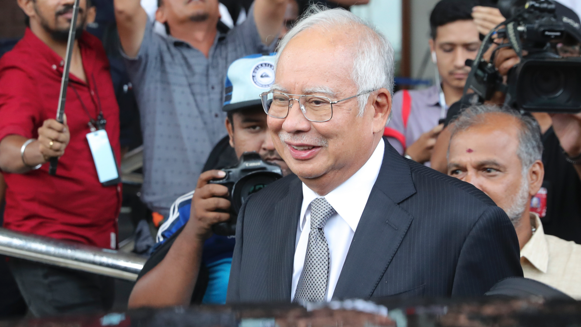 Malaysia's former Prime Minister Najib Razak, center, gets into a car after his court appearance at the Kuala Lumpur High Court in Kuala Lumpur, Malaysia, Monday, April 15, 2019. The corruption trial of Najib entered its second day, with a central bank official testifying that he has documents showing money from a company linked to a state investment fund was transferred into Najib’s personal bank account. (AP Photo/Vincent Thian)