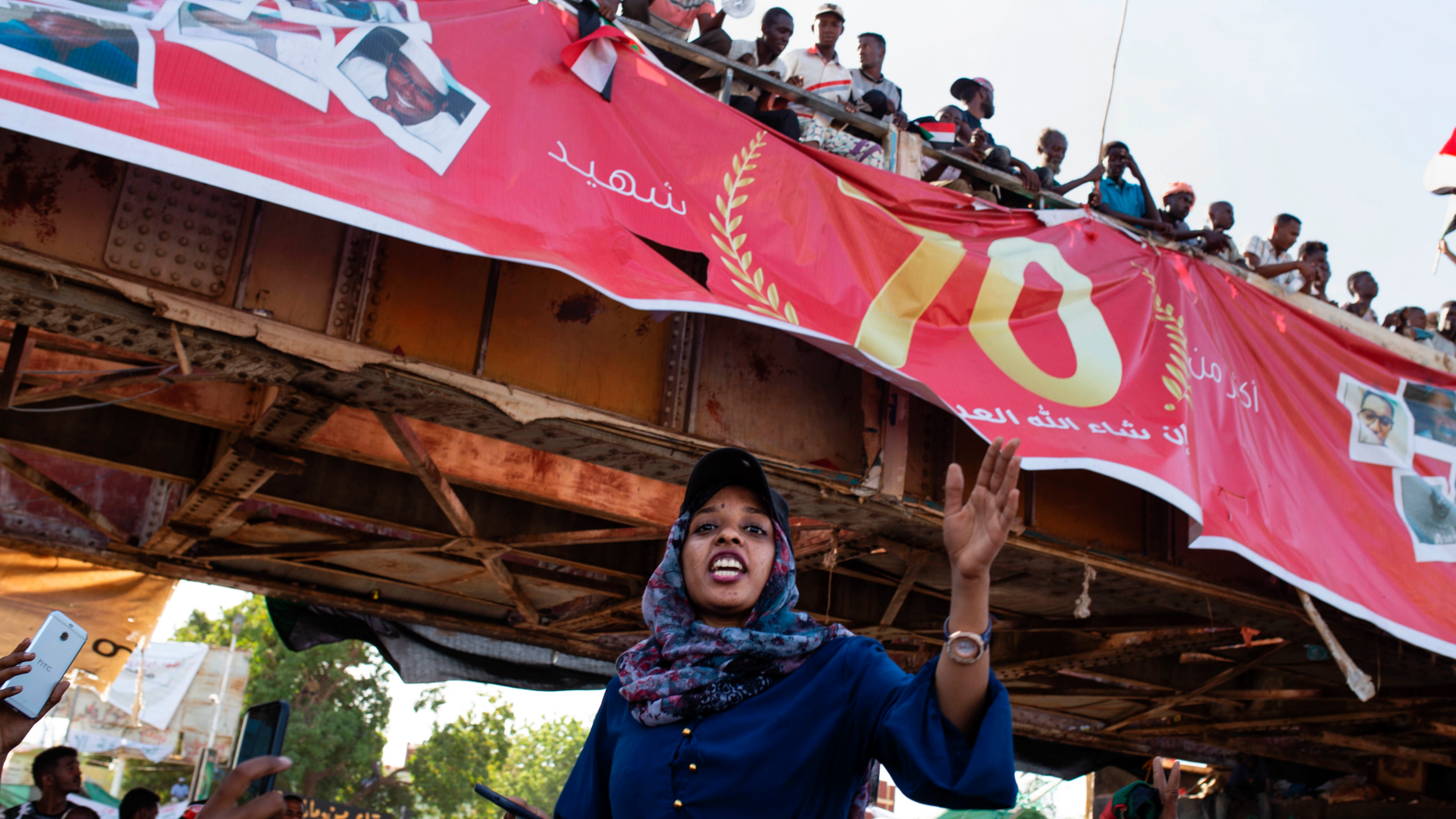 Demonstrators rally near the military headquarters in Khartoum, Sudan, Monday, April 15, 2019. The Sudanese protest movement on Monday welcomed the "positive steps" taken by the ruling military council, which held talks over the weekend with the opposition leaders and released some political prisoners. The praise came despite a brief incident earlier Monday where activists said soldiers attempted to disperse the ongoing protest sit-in outside the military headquarters in the capital, Khartoum, but eventually backed off. (AP Photo/Salih Basheer)