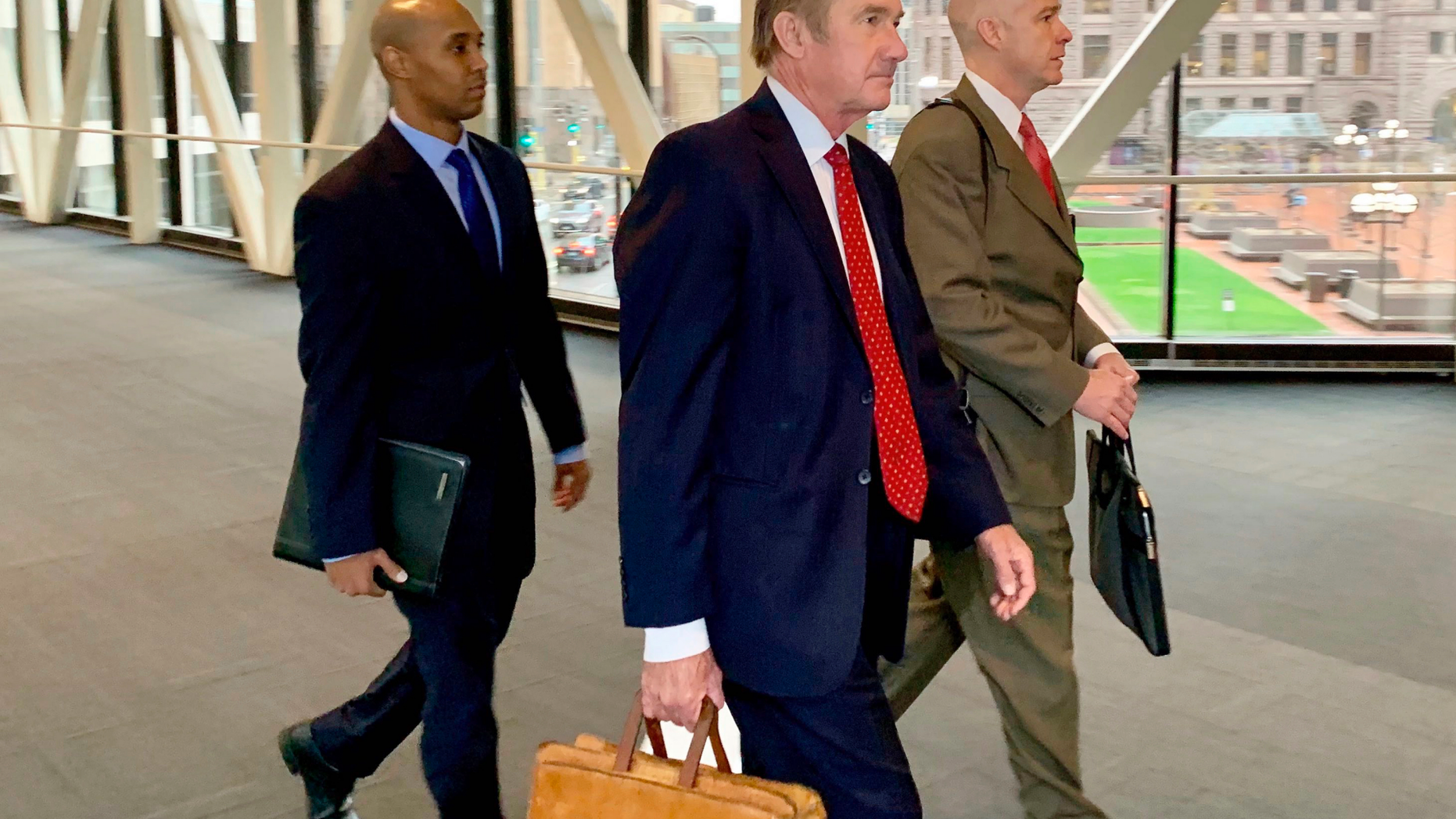 Former Minneapolis police officer Mohamed Noor, left, arrived with his defense attorneys Peter Wold, center, and Thomas Plunkett, right, on April 17, 2019, before another day of testimony in Noor's murder and manslaughter trial in Minneapolis. Noor is accused of fatally shooting an unarmed woman, Justine Ruszczyk Damond, on July 15, 2017, after she called 911 to report a possible sexual assault near her home. (AP Photo/Jeff Baenen)