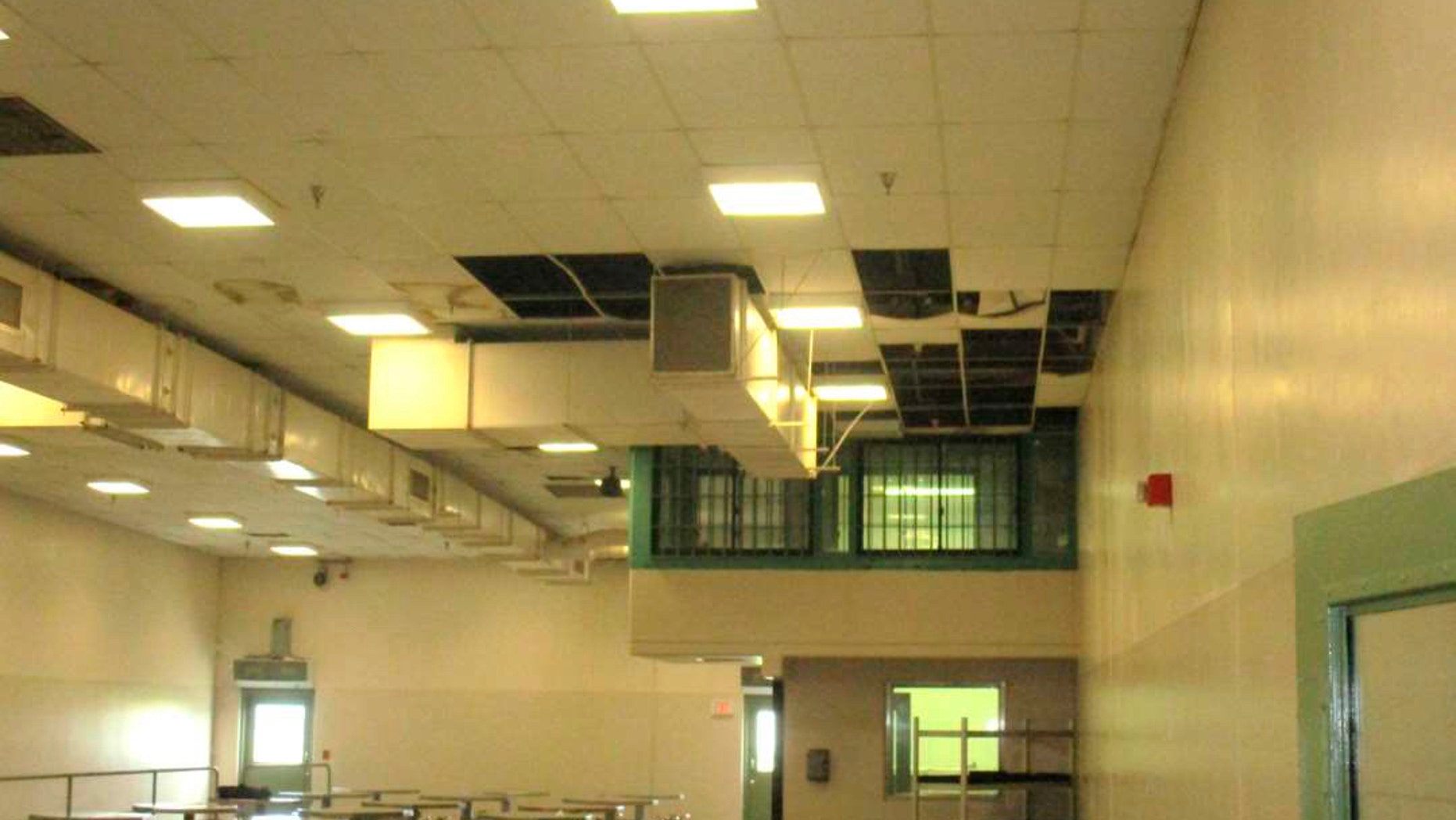 In this undated photo provided by the Prison Law Office, a non-profit public interest law firm that provides free legal services to prison inmates, is a dining hall where damaged ceiling tiles have been removed at the California Substance Abuse Treatment Facility and State Prison in Corcoran, Calif. California is spending $260 million over four years to repair leaking roofs and clear dangerous mold that imperils more than two dozen deteriorating prisons. An inmate lawsuit over the conditions says the repairs aren't moving fast enough. (Prison Law Office via AP)