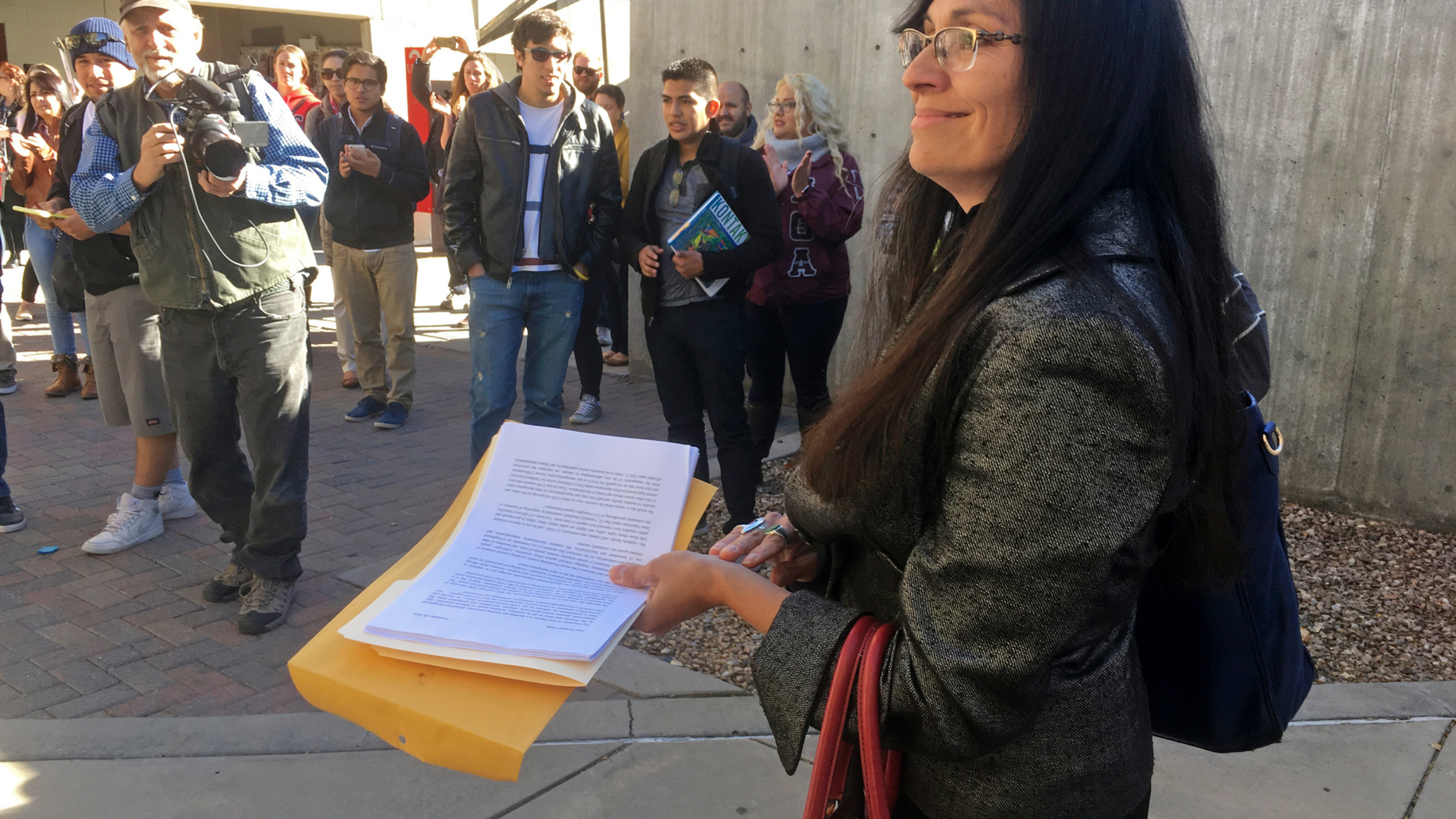 FILE - In this Nov. 18, 2016 file photo, University of New Mexico Chicana and Chicano studies professor Irene Vasquez holds a letter with hundreds of signatures, asking school president Bob Frank to declare the campus a "sanctuary university," in Albuquerque, N.M. Vasquez and other Mexican American scholars from universities across the country are gathering in Albuquerque on Wednesday, April 3, 2019, for an annual four-day national conference amid uncertainty on immigration and ethnic studies battles on college campuses. (AP Photo/Russell Contreras, File)