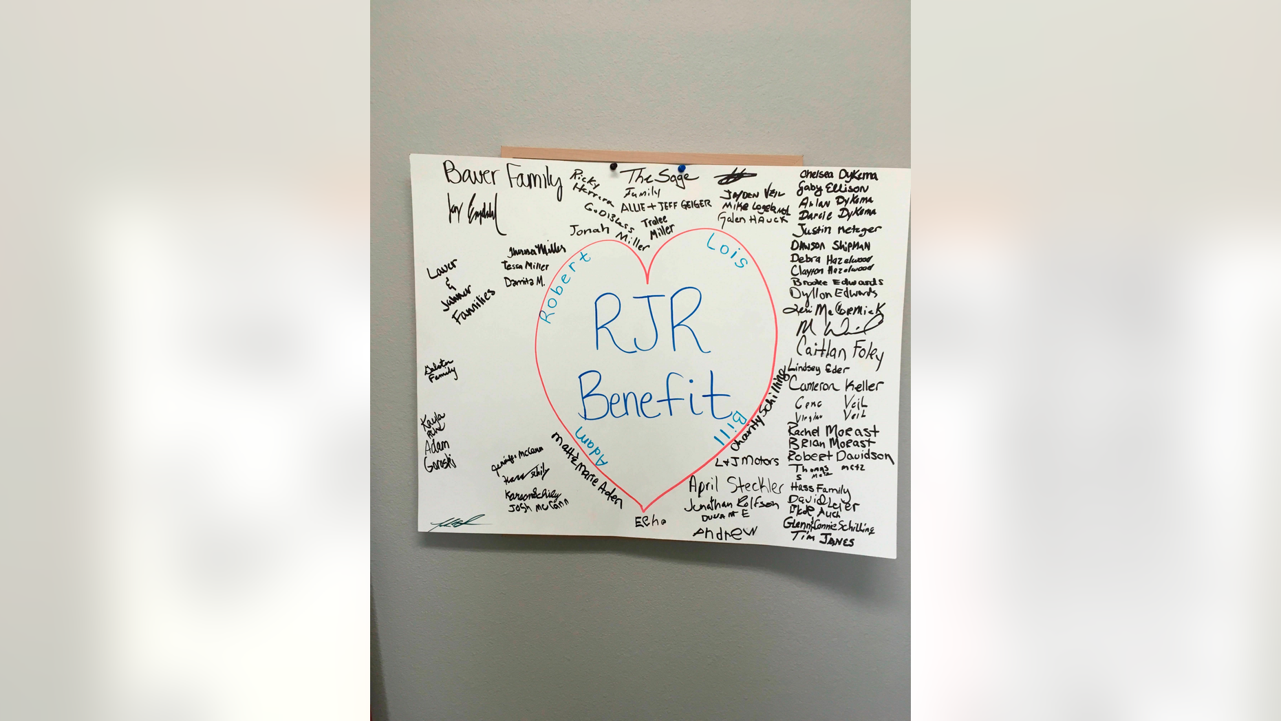 In this Monday, April, 15, 2019 photo, is a poster that numerous people have signed in the foyer of RJR Maintenance and Management in Mandan, North Dakota, where four employees were slain on April 1, 2019. (AP Photo Blake Nicholson)