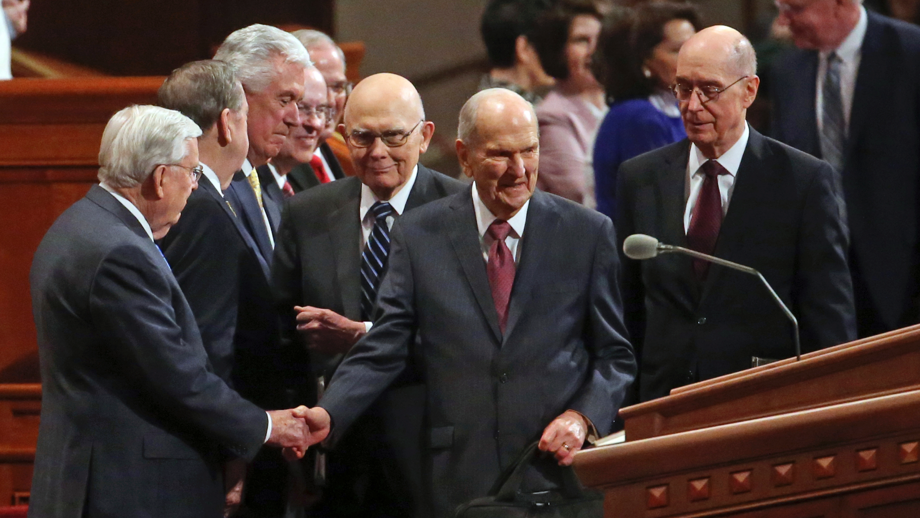 The Church of Jesus Christ of Latter-day Saints President Russell M. Nelson, center, greets the conference of The Church of Jesus Christ of Latter-day Saints Saturday, April 6, 2019, in Salt Lake City. Church members are preparing for more changes as they gather in Utah for a twice-yearly conference to hear from the faith's top leaders. (AP Photo/Rick Bowmer)