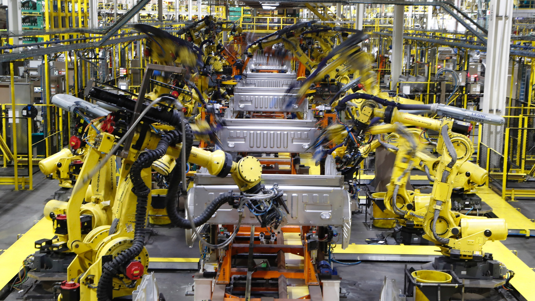 FILE- In this Sept. 27, 2018, file photo robots weld the bed of a 2018 Ford F-150 truck on the assembly line at the Ford Rouge assembly plant in Dearborn, Mich. On Monday, April 1, the Institute for Supply Management, a trade group of purchasing managers, issues its index of manufacturing activity for March. (AP Photo/Carlos Osorio, File)