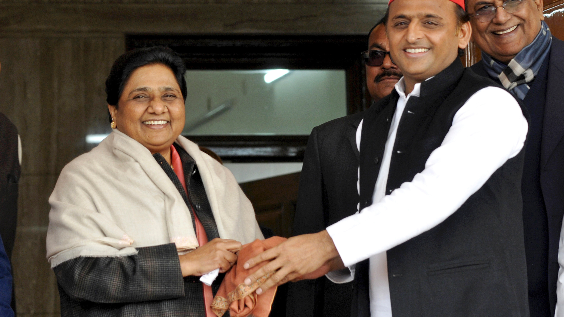 FILE - In this Jan. 15, 2019, file photo, Samajwadi Party President Akhilesh Yadav, right, greets Bahujan Samaj Party chief Mayawati on her birthday in Lucknow, India. Longtime political archrivals in India's most populous state have stitched an inventive political alliance that fuses votes from the ancient Hindu caste system to take on the ruling Hindu nationalist party-led government. (AP Photo/Nirala Tripathi)