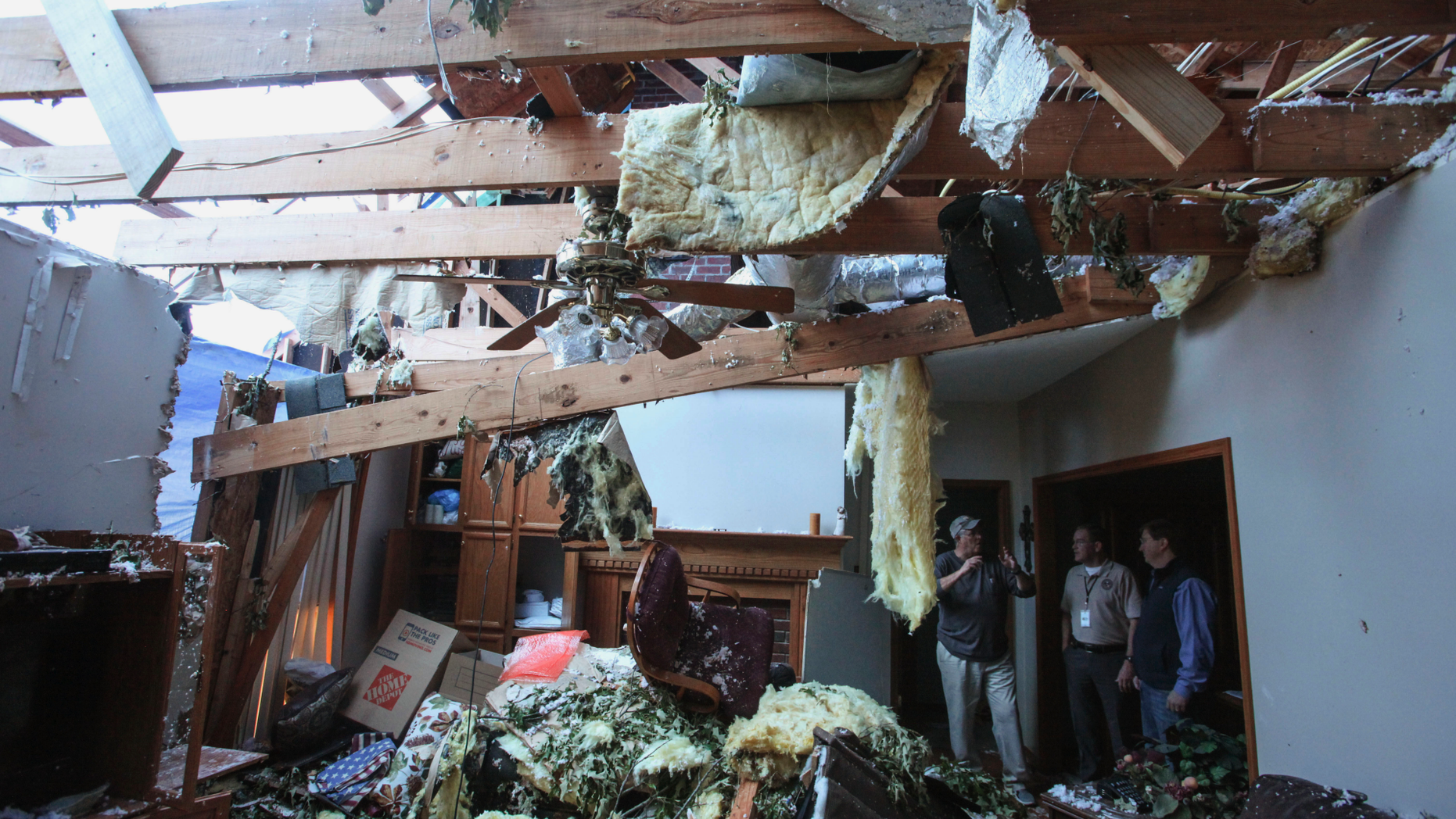 Pat McGuffie speaks with Warren County Sheriff Martin Pace and Lt. Gov. Tate Reeves about the damage at his home in Warren County, Miss., Tuesday, April 16, 2019, following Saturday evening's tornados that swept through Vicksburg and Warren County. (Courtland Wells/The Vicksburg Post via AP)