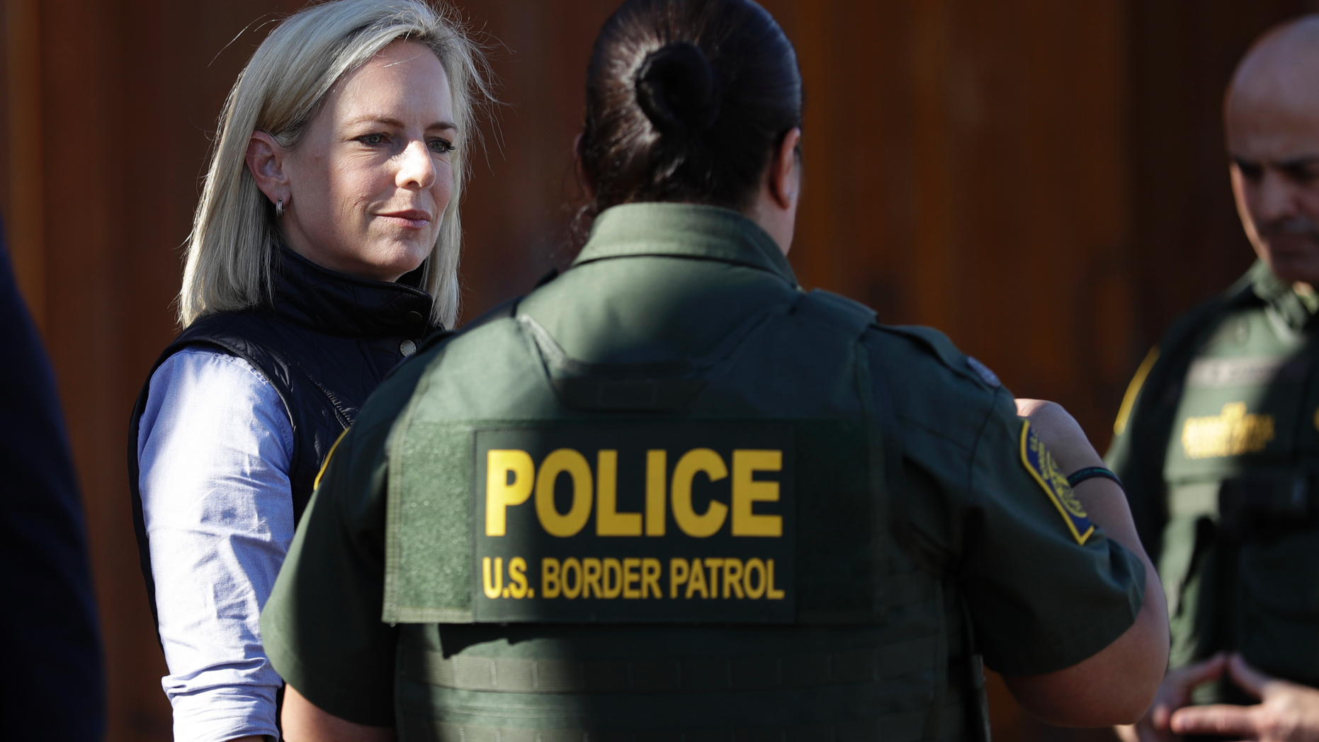 FILE - In this Friday, Oct. 26, 2018, file photo, U.S. Department of Homeland Security Secretary Kirstjen Nielsen, left, speaks with Border Patrol agents near a newly fortified border wall structure in Calexico, Calif. In a tweet on Sunday, April 7, 2019, President Donald Trump said he's accepted Nielsen's resignation. (AP Photo/Gregory Bull, File)