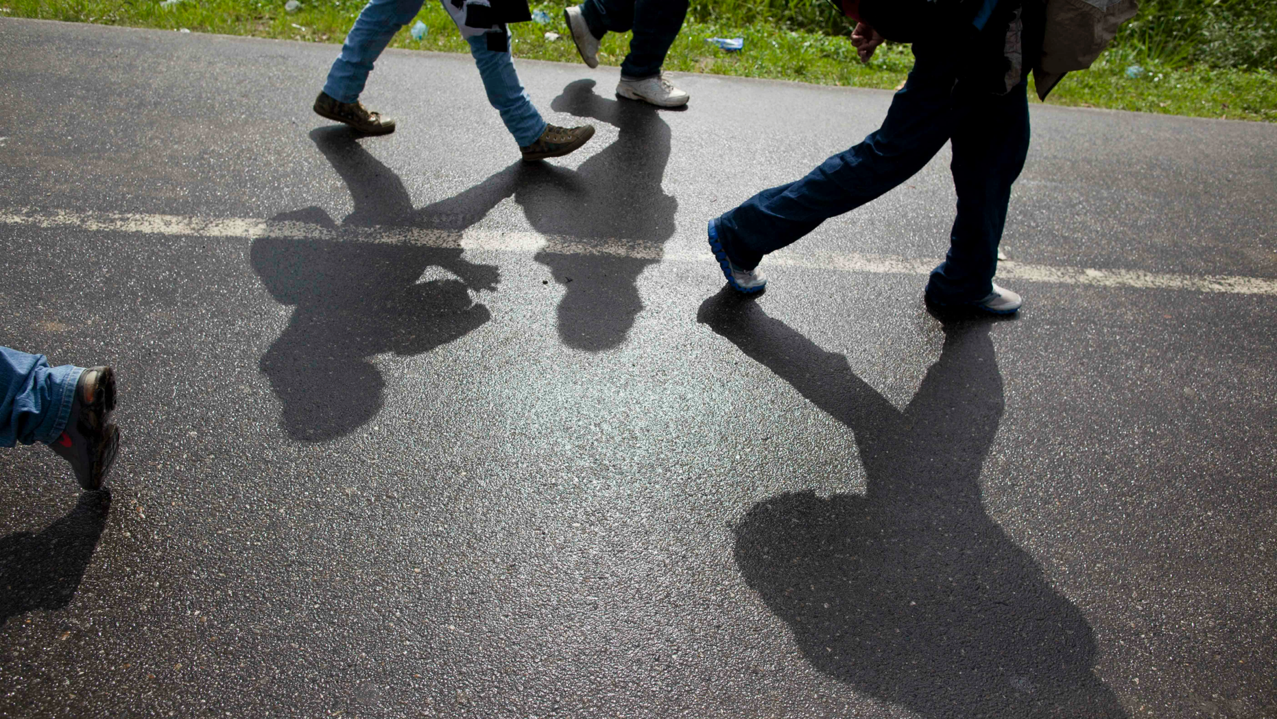 FILE - In this Aug. 14, 2012 file photo, Honduran migrants walk along a road after being deported by bus from Mexico to Corinto, Honduras, near the border with Guatemala. On Sunday, April 14, 2019, Mexican immigration officials said they have sent a group of just over 200 migrants back to Honduras, most of them families traveling with underage children, and that they were flown from the southeastern Mexican state of Veracruz to San Pedro Sula. (AP Photo/Esteban Felix, File)