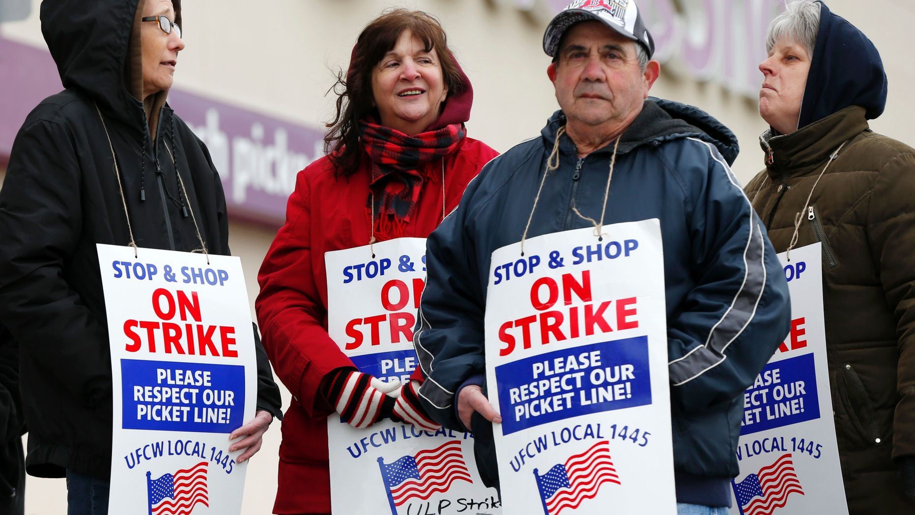 Striking workers stand on a picket line outside the Stop & Shop supermarket in Revere, Mass., Thursday, April 18, 2019. Some Jewish families in southern New England are preparing for Passover without the region's largest supermarket chain. Thousands of workers remain on strike and rabbis in Massachusetts, Connecticut and Rhode Island are advising their congregations not to cross the picket lines. (AP Photo/Michael Dwyer)