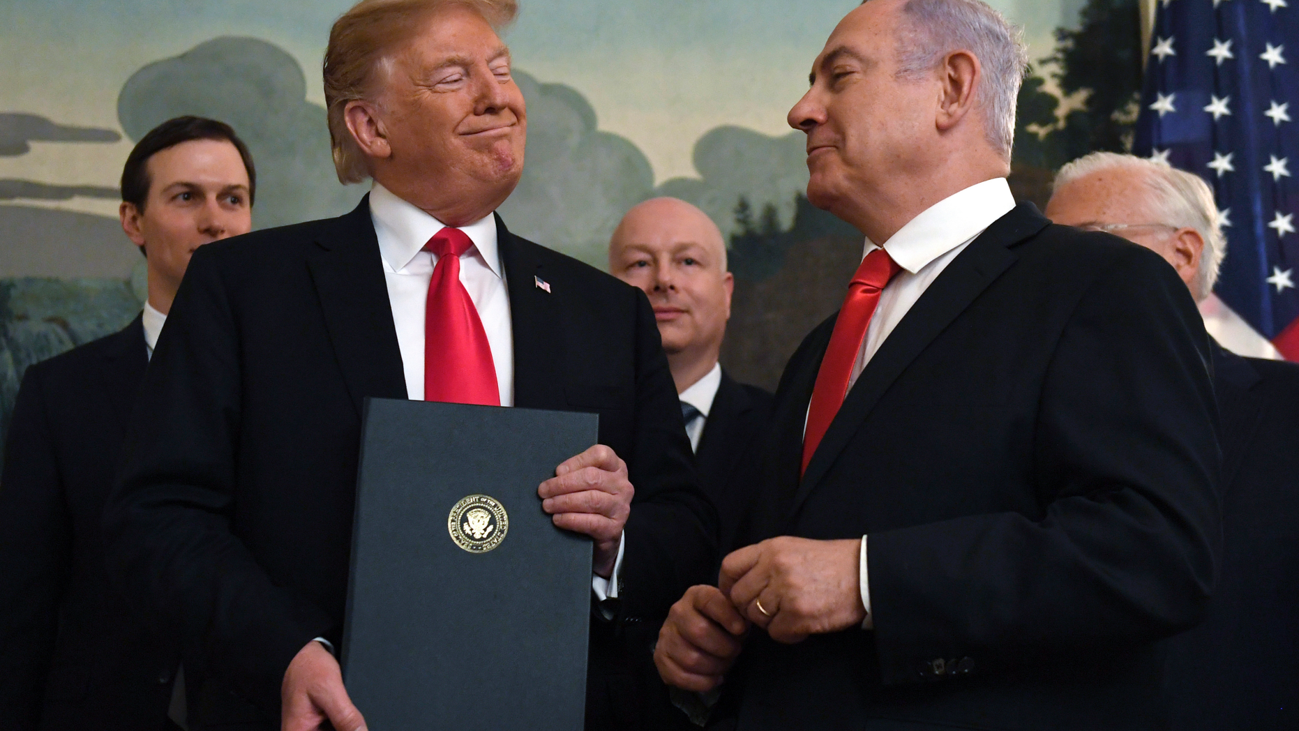 FILE - In this Monday, March 25, 2019 file photo, President Donald Trump smiles at Israeli Prime Minister Benjamin Netanyahu, right, after signing a proclamation in the Diplomatic Reception Room at the White House in Washington. Trump isn't on the ballot for Israel's national election, yet he's a dominant factor for many American Jews as they assess the high stakes of balloting on Tuesday, April 9, 2019. (AP Photo/Susan Walsh)
