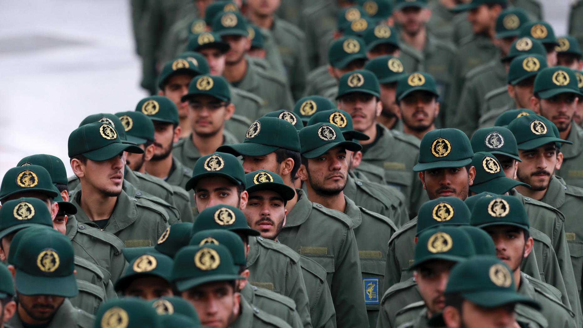 FILE - In this Feb, 11, 2019 file photo, Iranian Revolutionary Guard members arrive for a ceremony celebrating the 40th anniversary of the Islamic Revolution, at the Azadi, or Freedom, Square, in Tehran, Iran. President Donald Trump's administration is preparing to designate Iran's Revolutionary Guard as a "foreign terrorist organization." It's an unprecedented move that could have widespread implications for U.S. personnel and policy in the Mideast and elsewhere. U.S. officials say an announcement is expected Monday. (AP Photo/Vahid Salemi)