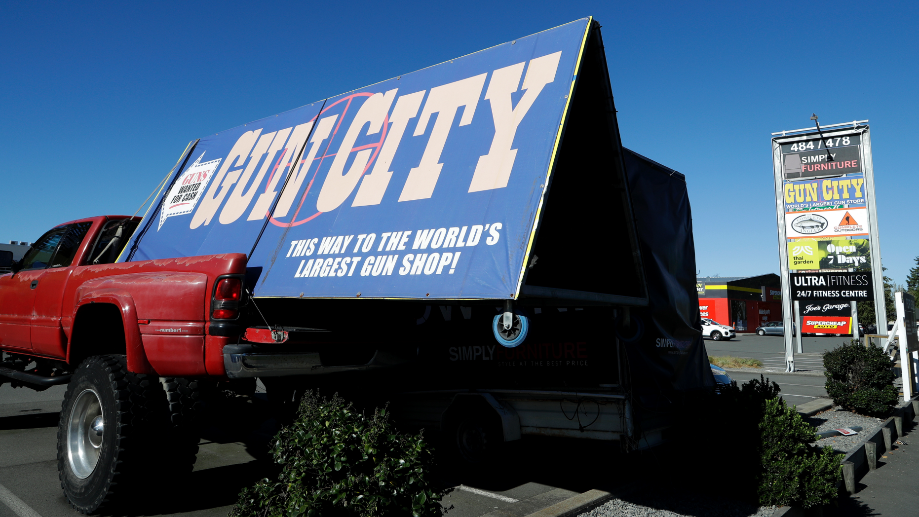 A billboard advertises a gun shop in Christchurch, New Zealand, Monday, April 1, 2019. New Zealand's government has introduced a bill to ban the types of weapons used by a terrorist to kill 50 people at two mosques. (AP Photo/Mark Baker)