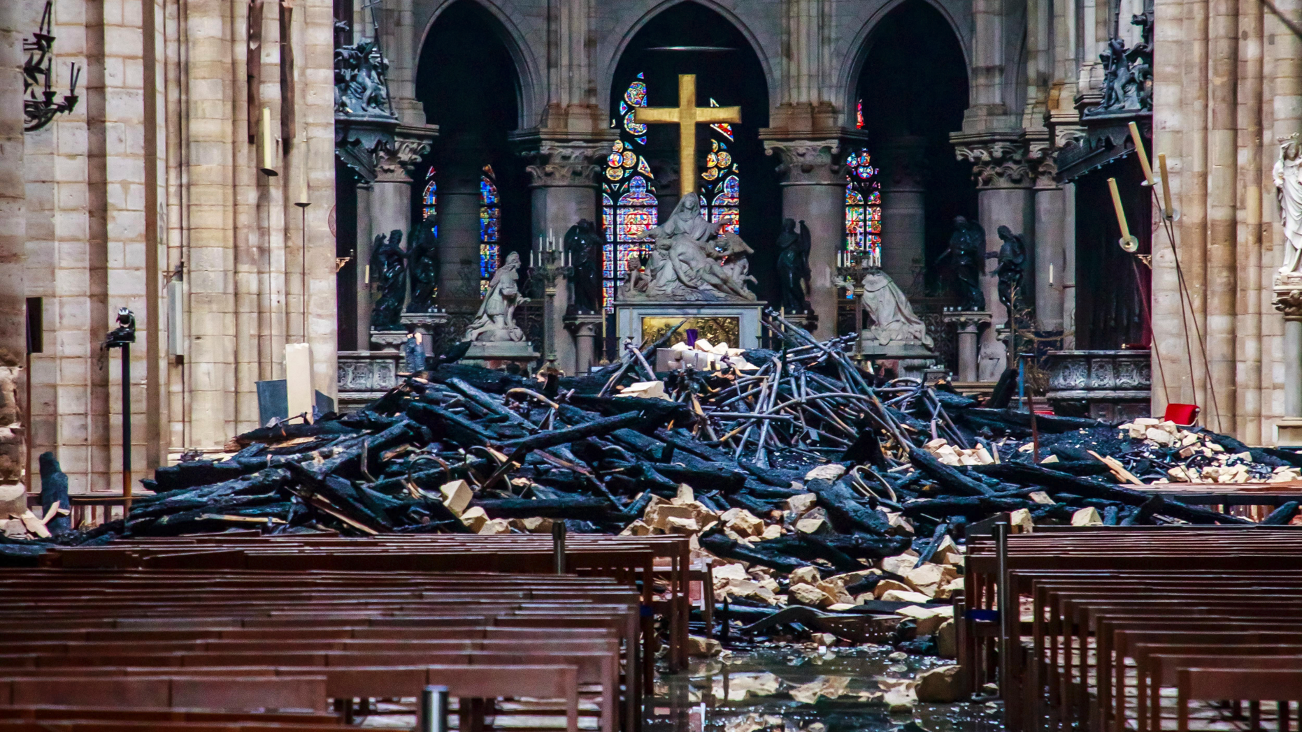 A hole is seen in the dome inside Notre Dame cathedral in Paris, Tuesday, April 16, 2019. Firefighters declared success Tuesday in a more than 12-hour battle to extinguish an inferno engulfing Paris' iconic Notre Dame cathedral that claimed its spire and roof, but spared its bell towers and the purported Crown of Christ. (Christophe Petit Tesson, Pool via AP)