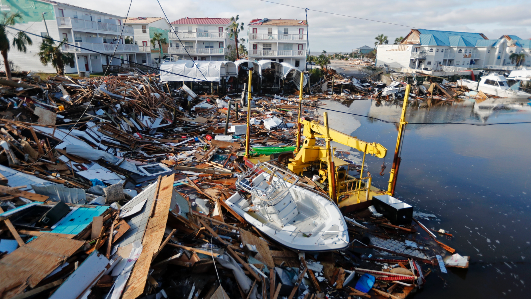 FILE - In this Oct. 11, 2018 file photo, a boat sits amidst debris in the aftermath of Hurricane Michael in Mexico Beach, Fla. Weather forecasters have posthumously upgraded last fall's Hurricane Michael from a Category 4 storm to a Category 5. The National Oceanic and Atmospheric Administration announced the storm's upgraded status Friday, making Michael only the fourth storm on record to have hit the U.S. as a Category 5 hurricane. (AP Photo/Gerald Herbert, File)