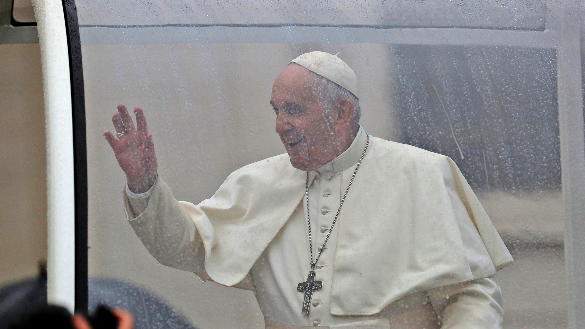 Raindrops cover the glass window as Pope Francis leaves on his pope mobile at the end of his weekly general audience in St. Peter's Square, at the Vatican, Wednesday, April 10, 2019. (AP Photo/Andrew Medichini)