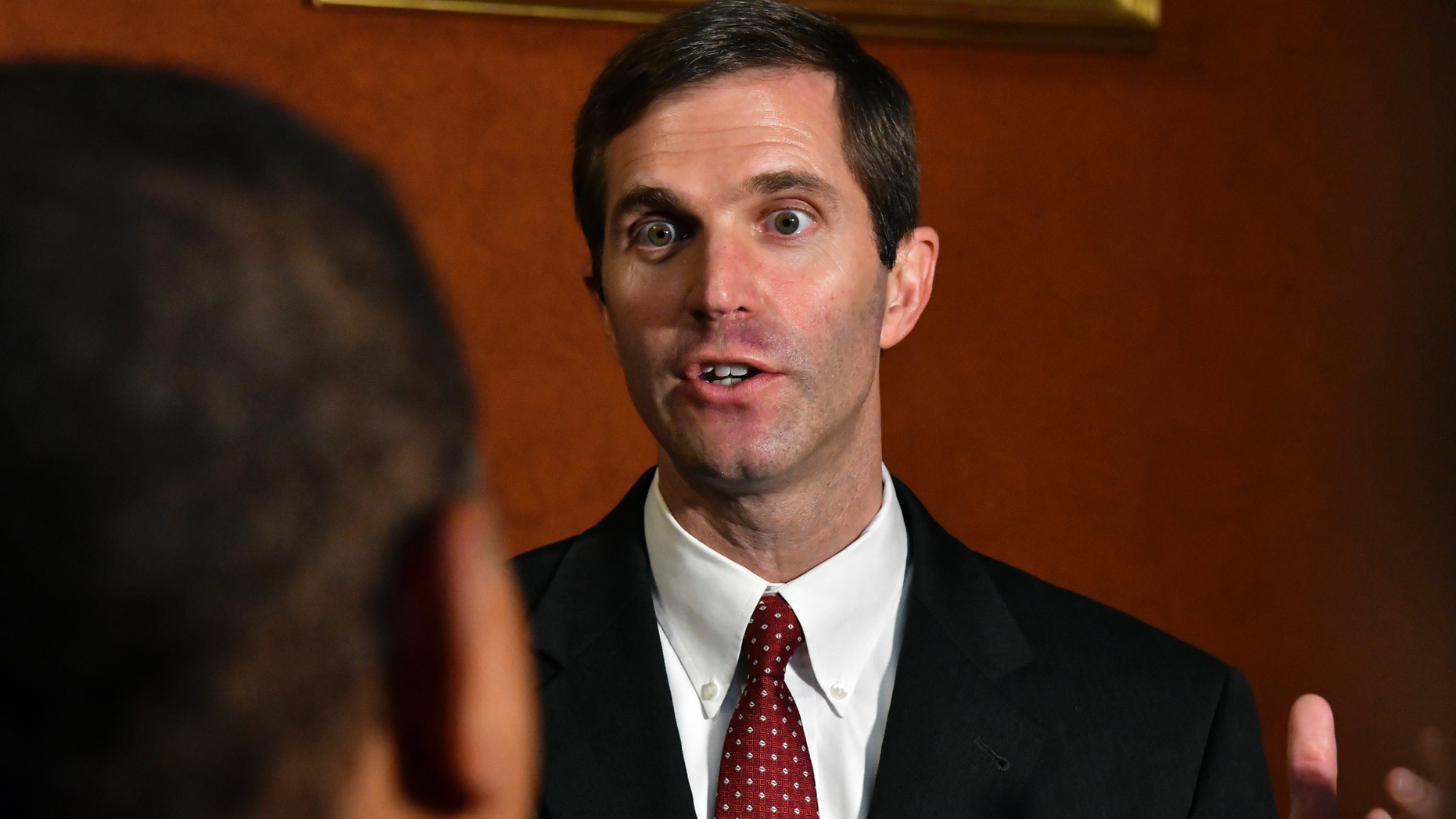FILE - In a Thursday, Sept. 20, 2018 file photo, Kentucky Attorney General Andy Beshear answers a reporters' question following his presentation to the Supreme Court at the Kentucky Capitol in Frankfort, Ky. says it disagrees with Kentucky’s Democratic attorney general over the validity of a state law that could determine if the state’s only abortion clinic stays open. The disagreement stems from a legal brief filed by Attorney General Beshear in support of the clinic, EMW Women’s Surgical Center in Louisville. (AP Photo/Timothy D. Easley, File)