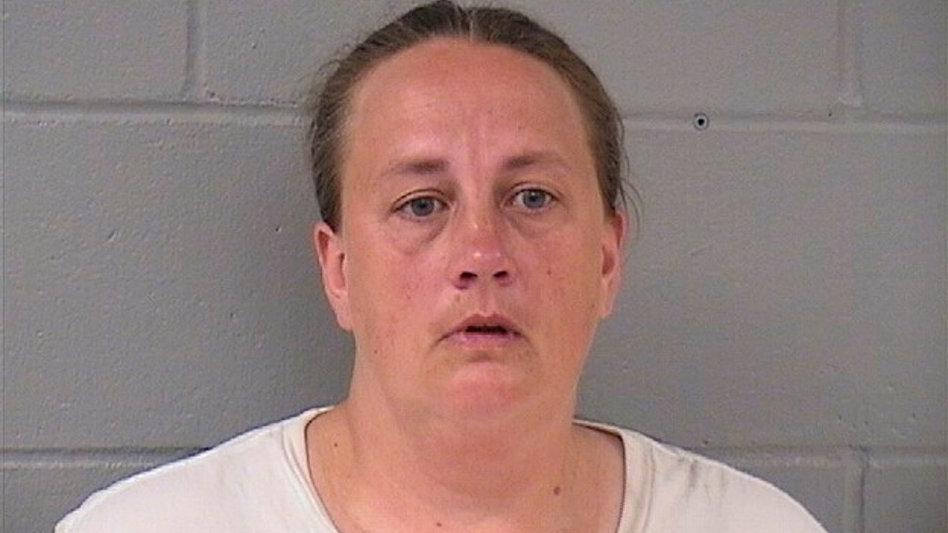 his booking photo taken Sept. 12, 2018 from the Hardin County Sheriff’s Office shows Traci Tyler. Tyler is charged with kidnapping for confining her boyfriend's 8-year-old son under basement stairs has been convicted of a lesser charge. A judge on Wednesday, April 10, 2019 found Tyler guilty of misdemeanor false imprisonment. Prosecutors say she and the boy's father, Alex Shadlow, locked the boy in the basement of their Ackley home for at least nine hours a day in summer 2017. (Hardin County Sheriff’s Office via AP)