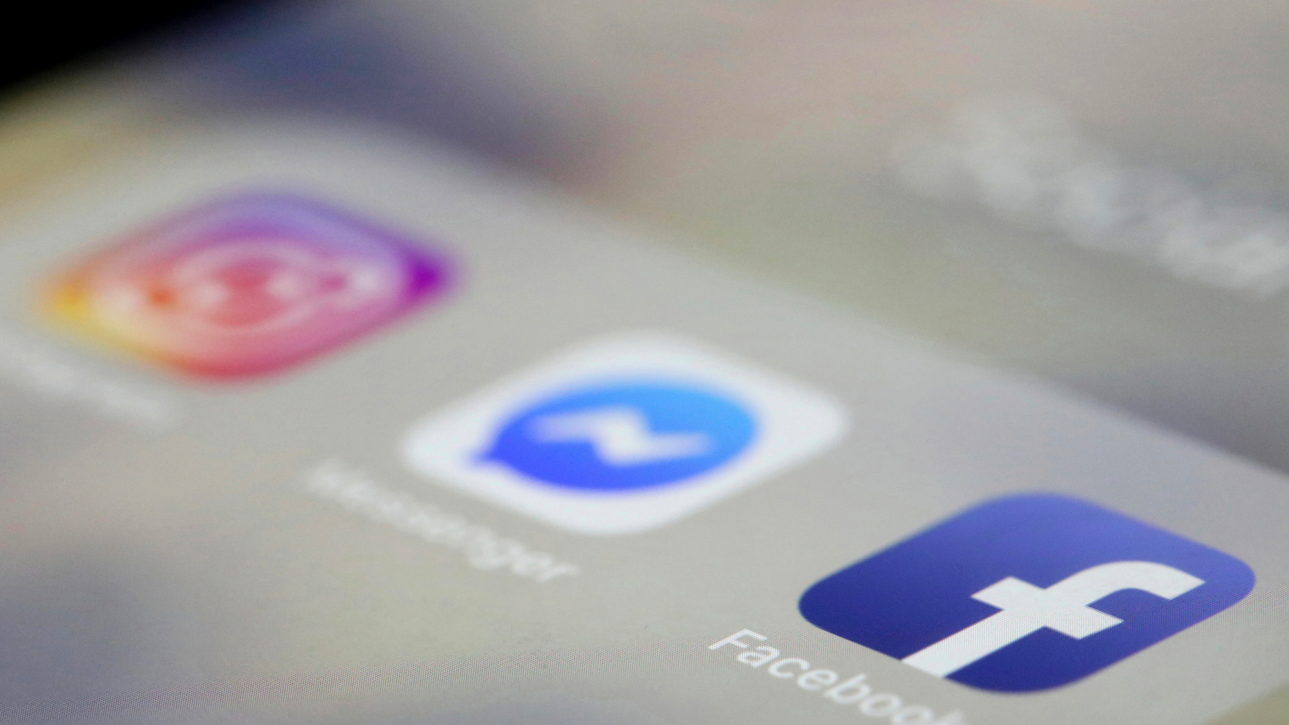 Facebook, Messenger and Instagram apps are displayed on an iPhone. Facebook, Instagram and WhatsApp are down. The three social media platforms, including Facebook Messenger, did not load early Sunday, April 14 (AP Photo / Jenny Kane, File).