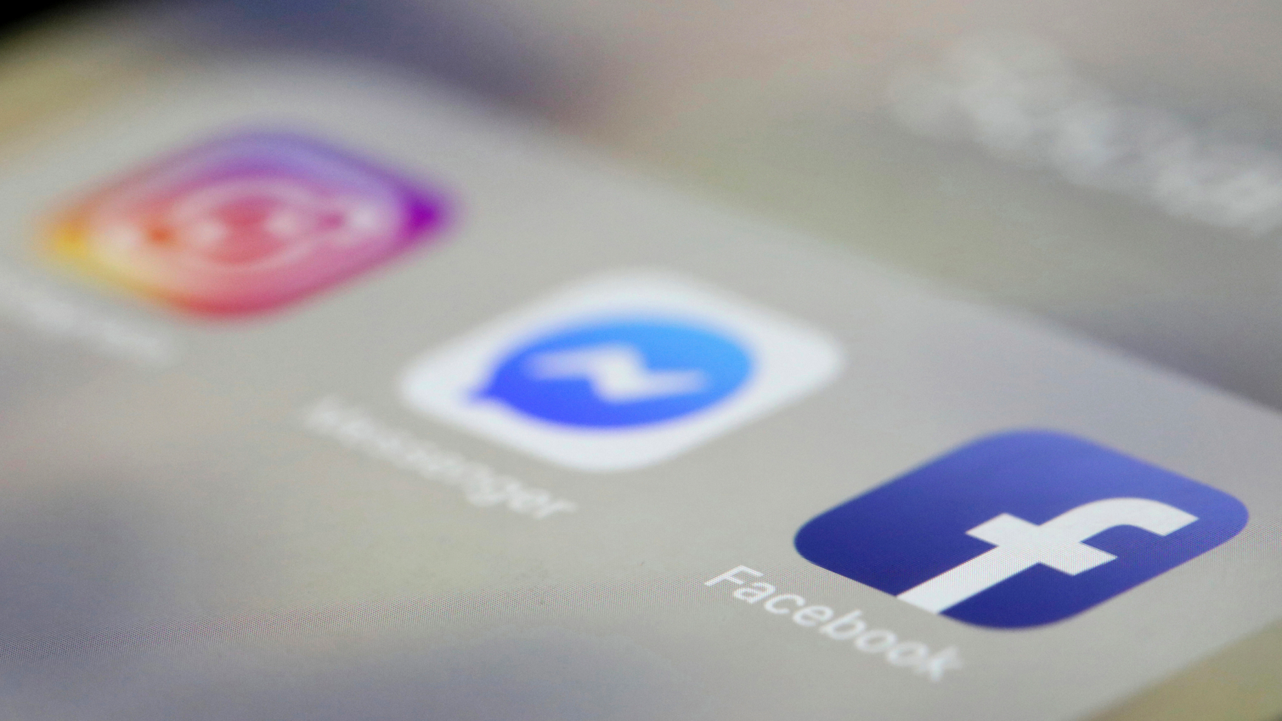 Facebook, Messenger and Instagram apps are displayed on an iPhone. Facebook, Instagram and WhatsApp are down. The three social media platforms, including Facebook Messenger, did not load early Sunday, April 14 (AP Photo / Jenny Kane, File).