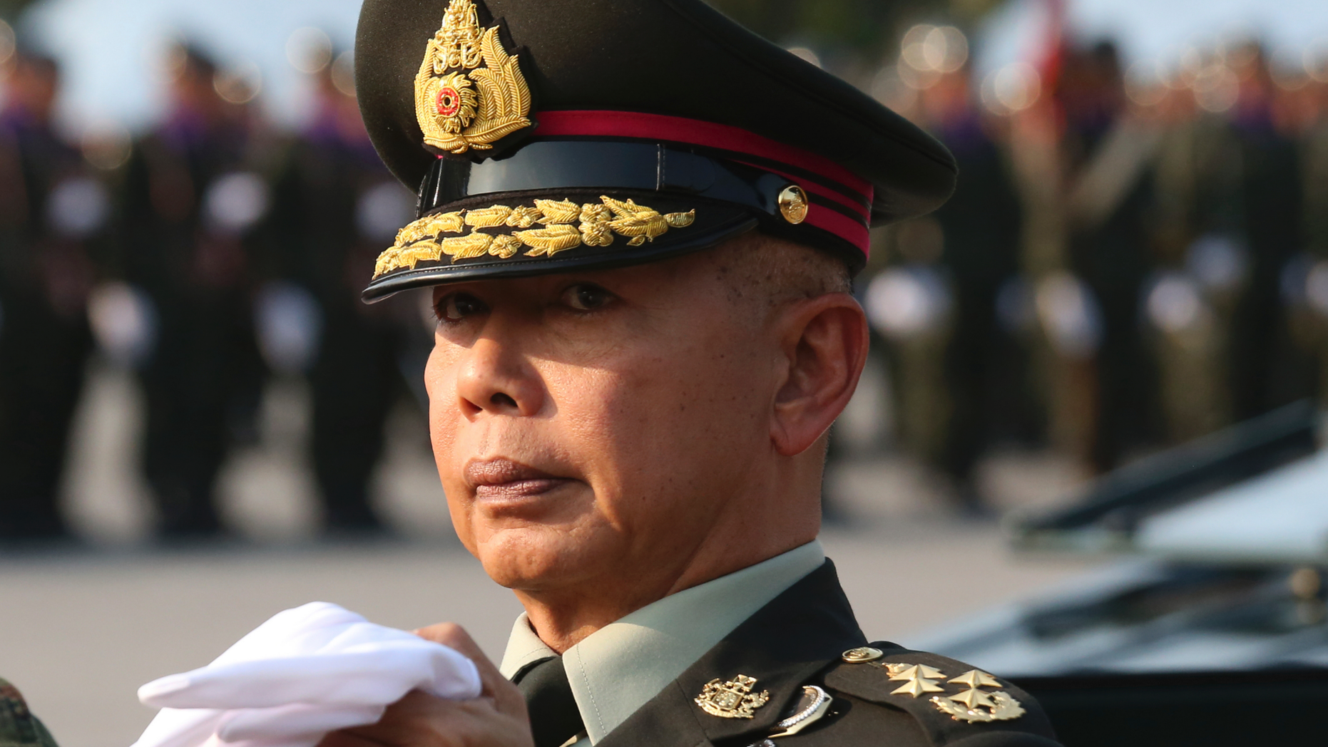 In this Friday, Jan. 18, 2019, file photo, Thai army chief Gen. Apirat Kongsompong reviews the guard of honor during the Royal Thai Armed Forces Day ceremony at a military base in Bangkok, Thailand. Apirat has warned that the military will strongly fight any moves that threaten the country's system of a constitutional monarchy with the king as head of state. (AP Photo/Sakchai Lalit)