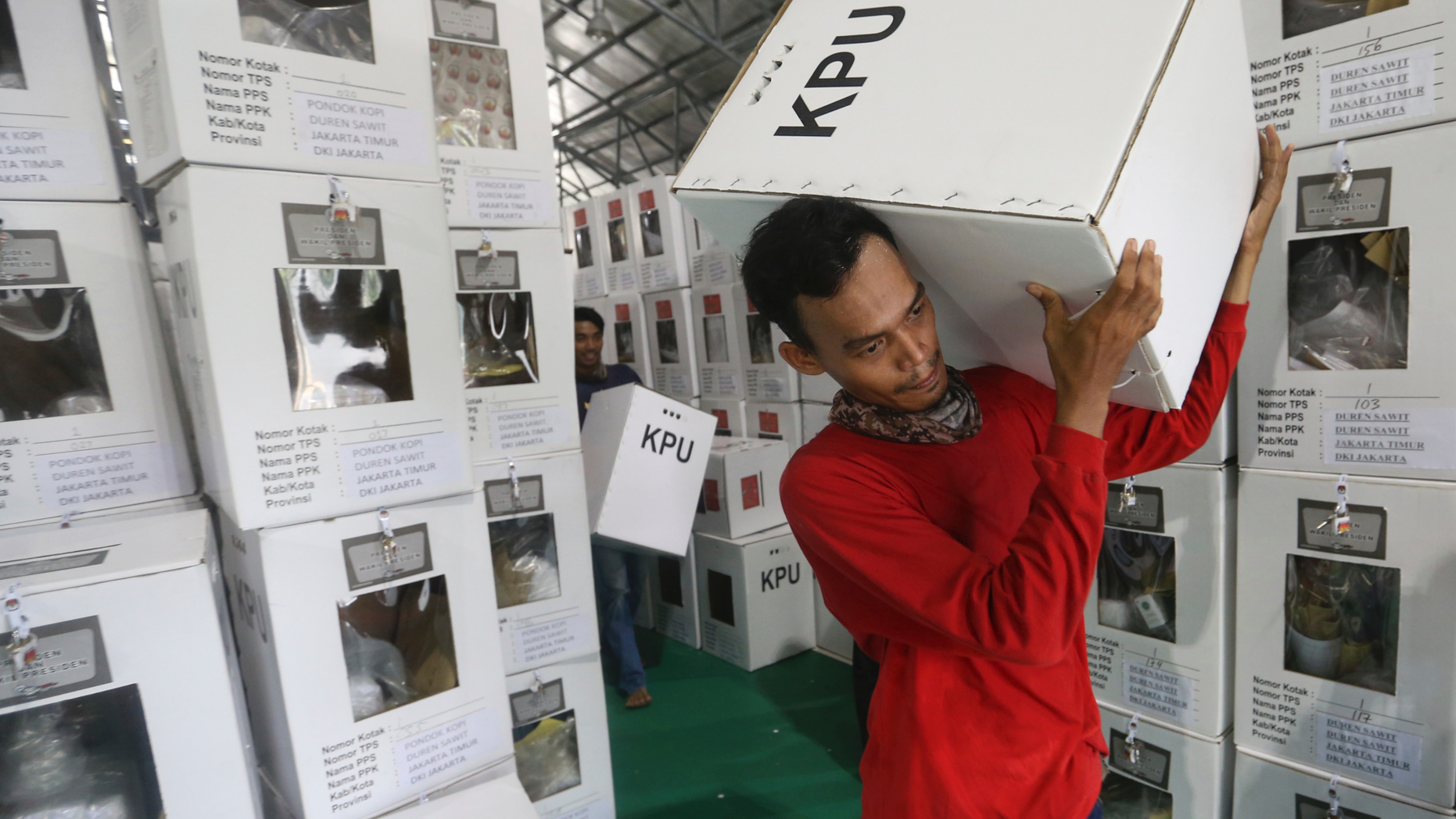 Workers carry ballot boxes to be distributed to polling stations in Jakarta, Indonesia, Tuesday, April 16, 2019. Nearly 193 million Indonesians are eligible to vote in presidential and legislative elections on Wednesday. President Joko Widodo, the first Indonesian president from outside the Jakarta elite, is competing against Prabowo Subianto, a former special forces general from the era of authoritarian rule under military dictator Suharto.(AP Photo/Achmad Ibrahim)