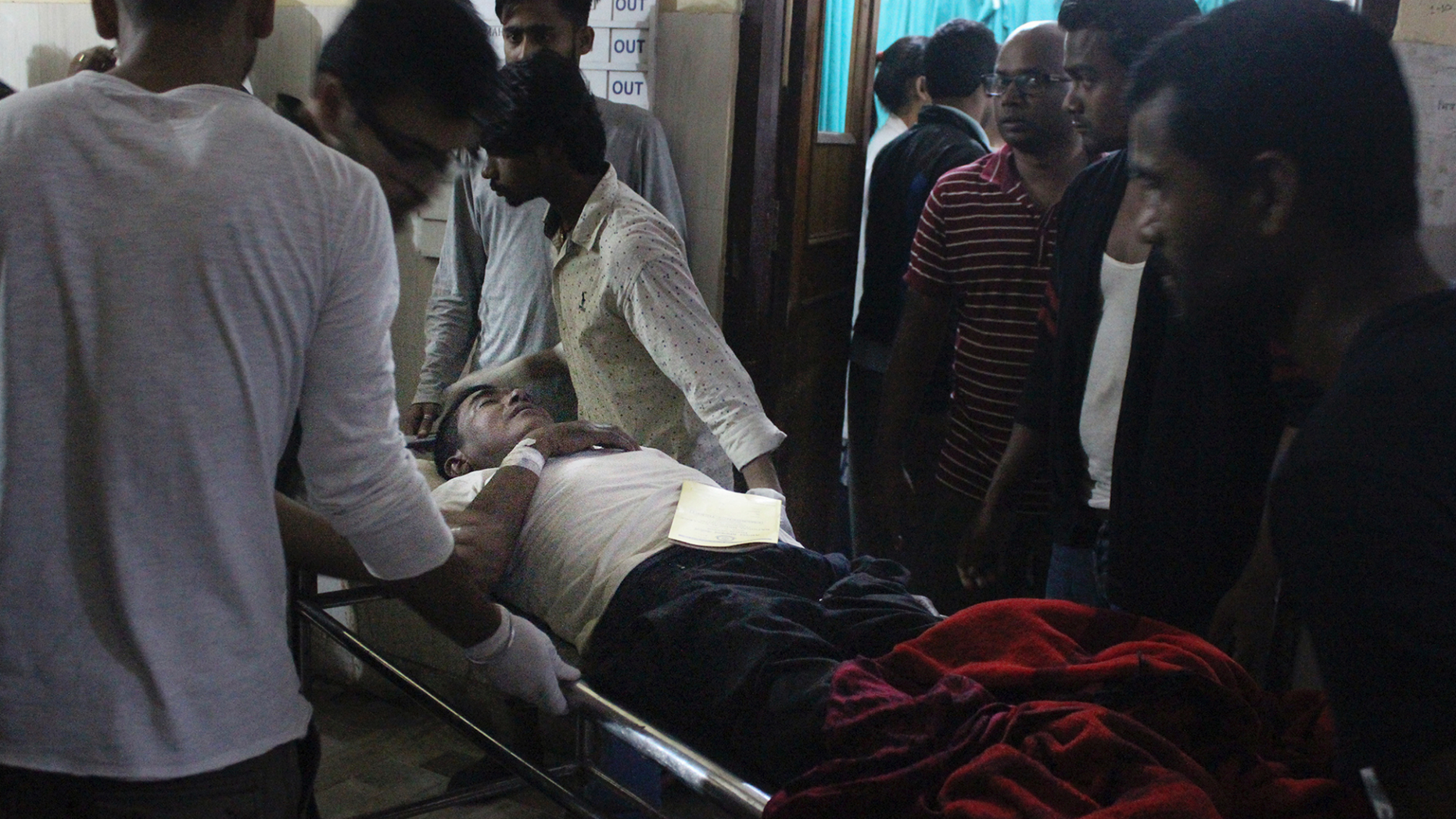 An Injured of rain storm from Bara district is being brought to a government hospital, in Birgunj, 136 kilometers (85 miles) from Kathmandu, Nepal, March 31, 2019. Officials say many people were killed and hundreds were injured by a rainstorm that swept southern Nepal on Sunday. (AP Photo/Jiyalal Sah)