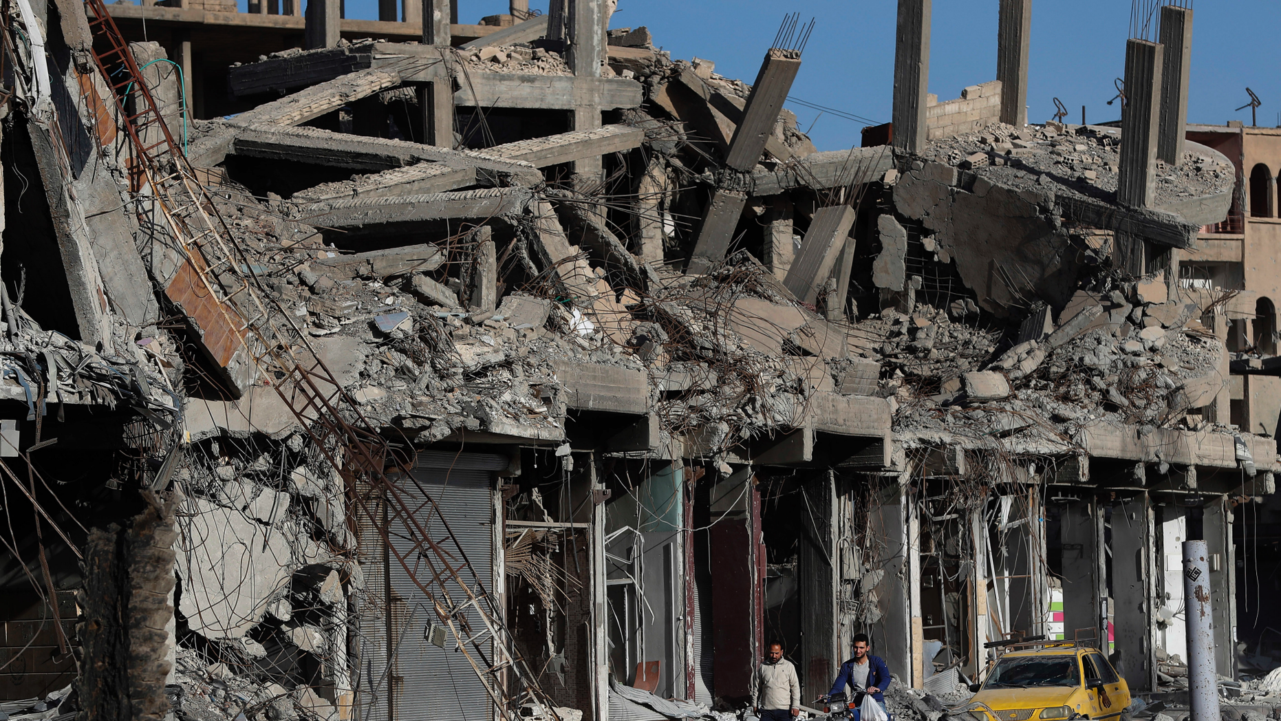 FILE - In this April 5, 2018 file photo, destroyed buildings line a street damaged during fighting between U.S.-backed Syrian Democratic Forces fighters and Islamic State militants, in Raqqa, Syria. Amnesty International and Airwars, a London-based watchdog group, said Thursday, April 25, 2019, that the U.S.-led coalition killed more than 1,600 civilians in the northern Syria city of Raqqa during months of bombardment that liberated it from the Islamic State group. They said the toll came after the “most comprehensive investigation into civilian deaths in a modern conflict.” (AP Photo/Hussein Malla, File)
