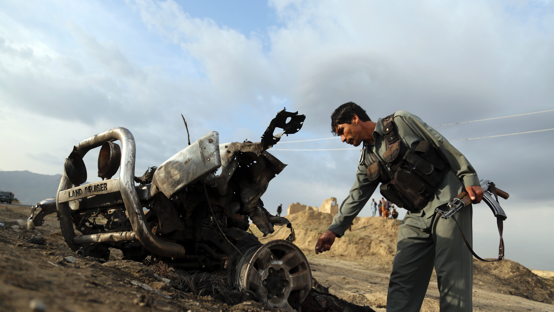 An Afghan security force check the site a day after an an attack near the Bagram Air Base, north of Kabul, Afghanistan, Tuesday, April 9, 2019. Three American service members and a U.S. contractor were killed when their convoy hit the roadside bomb on Monday near the main U.S. base in Afghanistan, the U.S. forces said. The Taliban claimed responsibility for the attack. (AP Photo/Rahmat Gul)