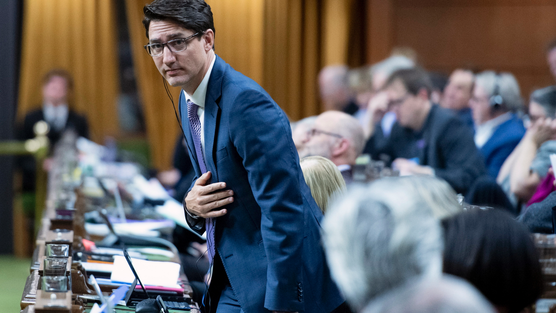 Canadian Prime Minister Justin Trudeau rises to vote during a marathon voting session as it continues into the night in the House of Commons on Parliament Hill in Ottawa, Ontario, on Wednesday, March 20, 2019. (Justin Tang/The Canadian Press via AP)