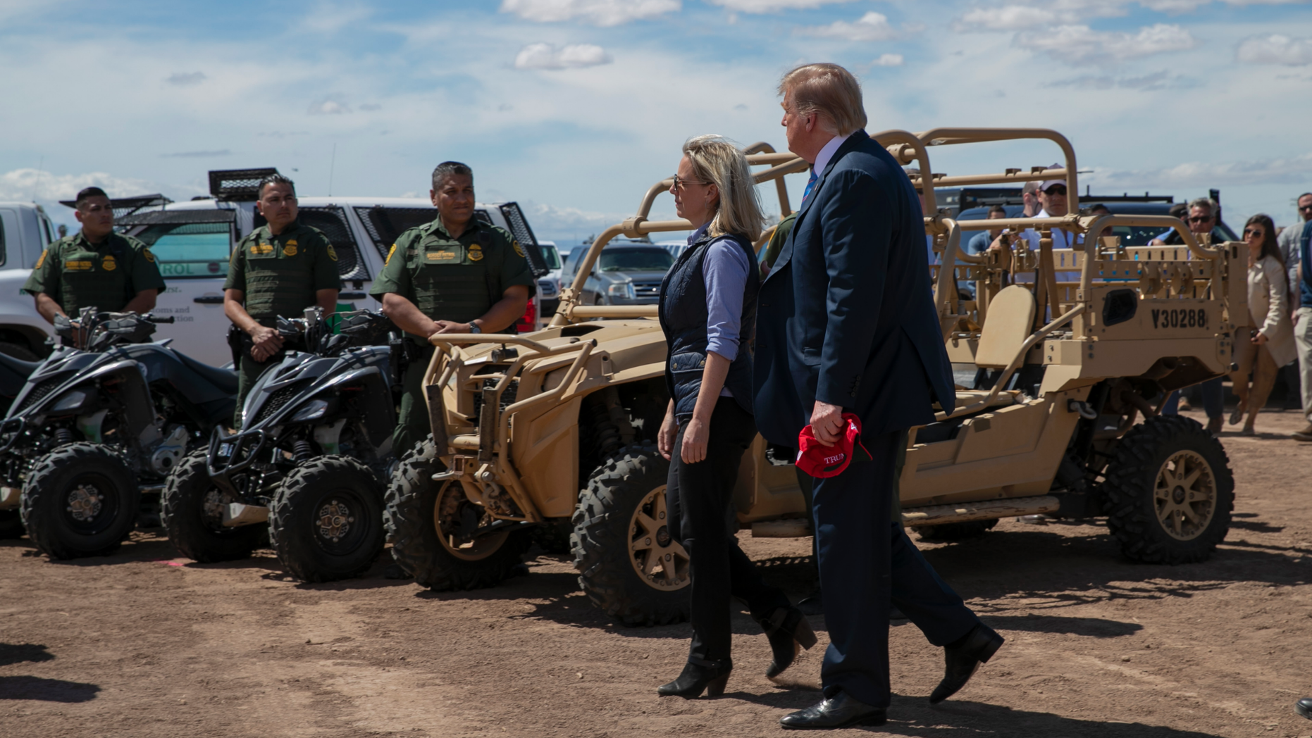President Donald Trump walks with Homeland Security Secretary Kirstjen Nielsen as they visit a newly constructed part of a border wall with Mexico in Calexico, Calif., Friday April 5, 2019. (AP Photo/Jacquelyn Martin)